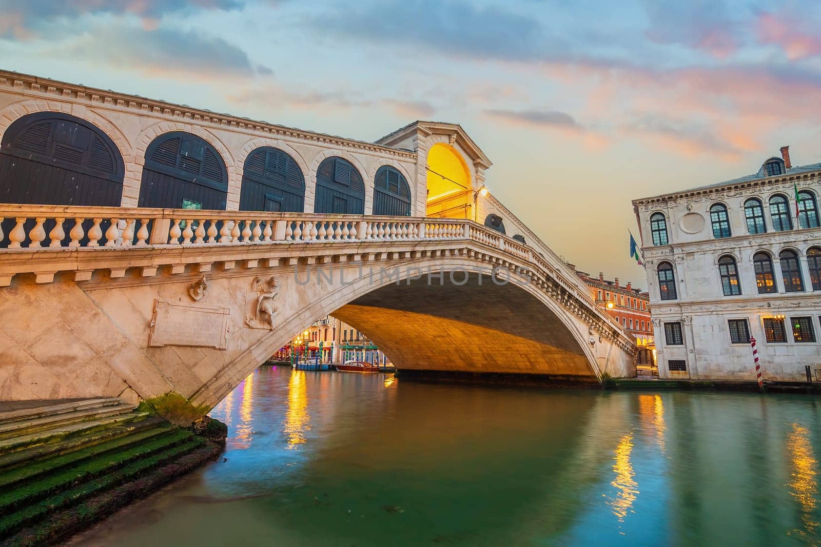 Panoramic view of famous Canal Grande with famous Rialto Bridge at sunset in Venice