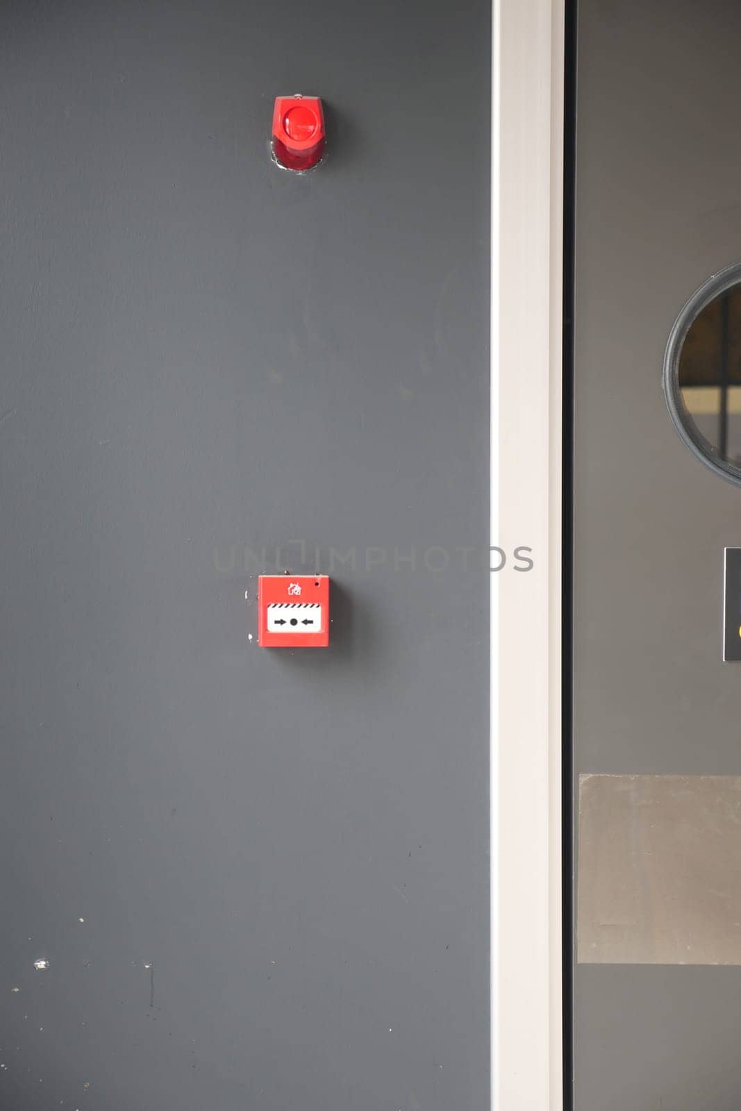 Red fire alarm button on wall