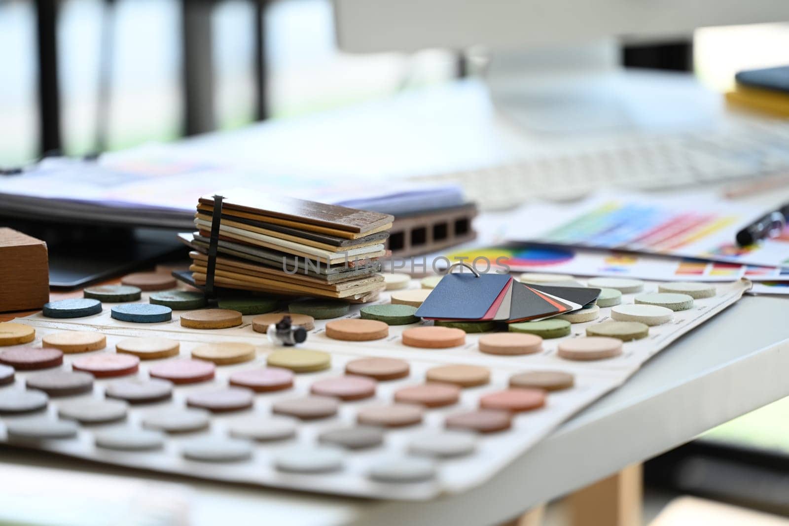 Material sample and color swatches on interior designer working desk.