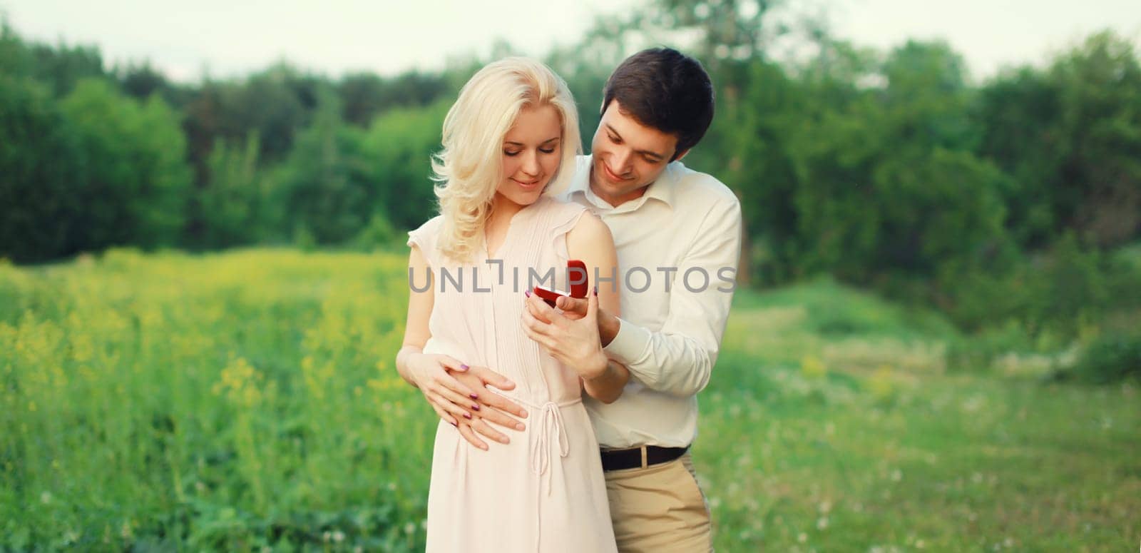 Wedding happy lovely young couple, man proposing a ring to his beloved woman outdoors in summer park by Rohappy