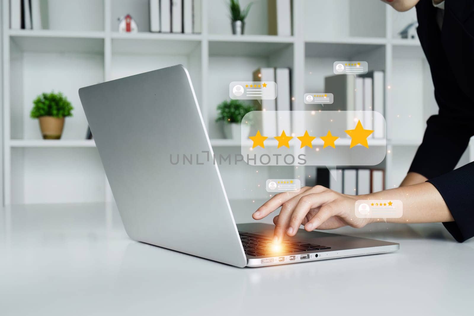 A woman is holding a tablet and pointing to a 5 star rating. Concept of accomplishment and satisfaction, as the woman is giving a thumbs up to the 5 star rating