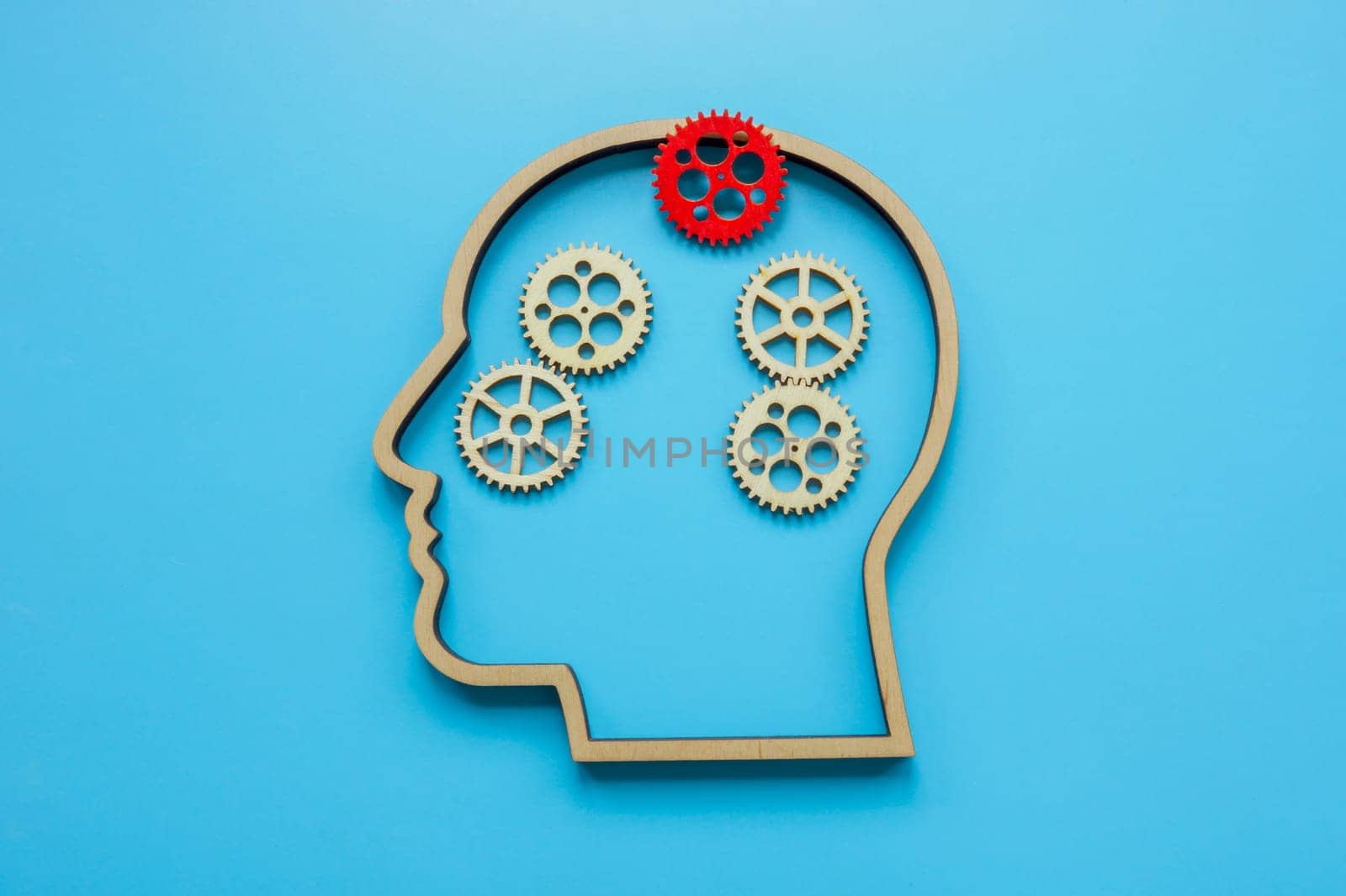 Head outline and gears without one as abstract of brain and mental health problems.