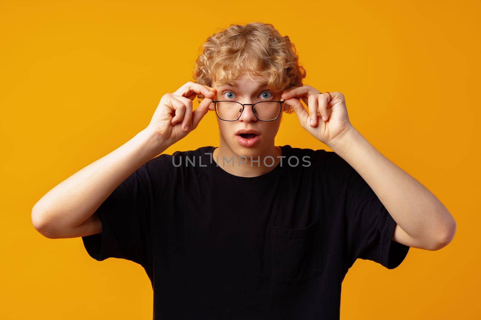 Young man over yellow background with surprise facial expression close up