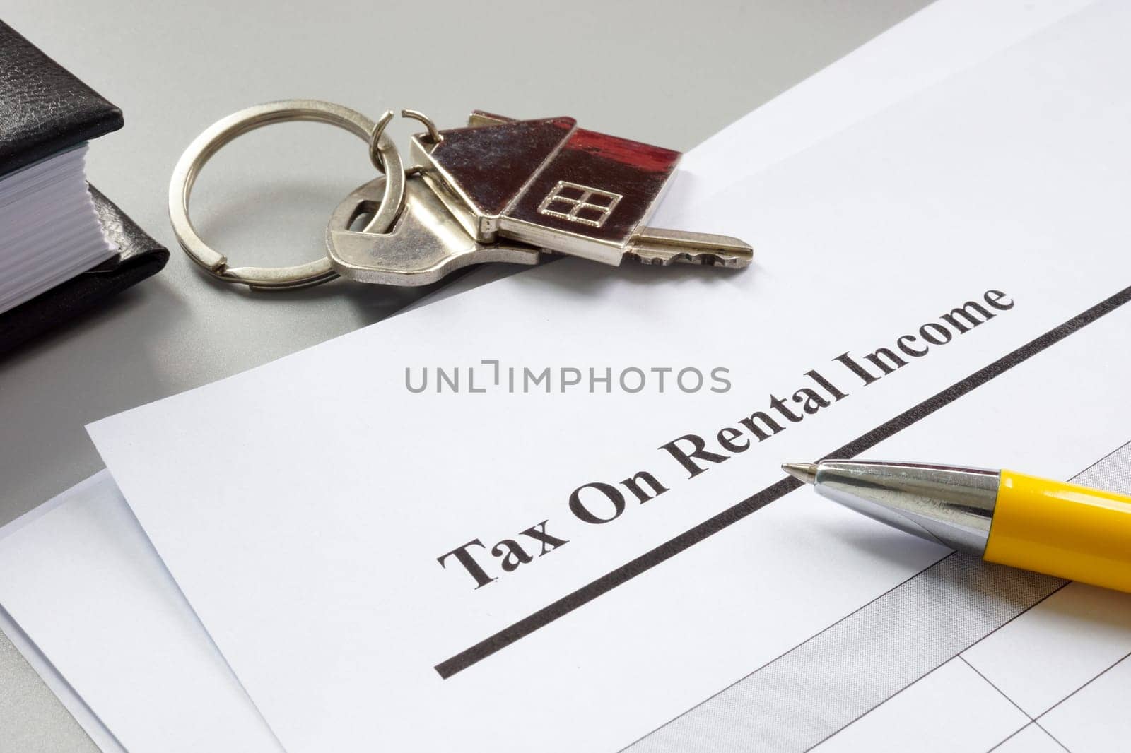 A key and papers about tax on rental income.