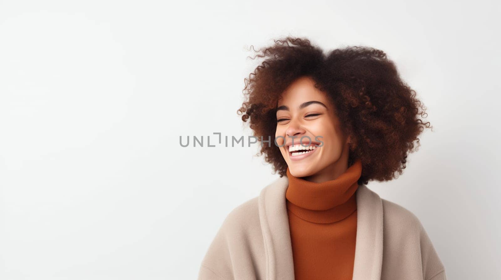 Portrait of beautiful happy smiling african young woman with toothy smile, curly hair, female black model posing on white studio background