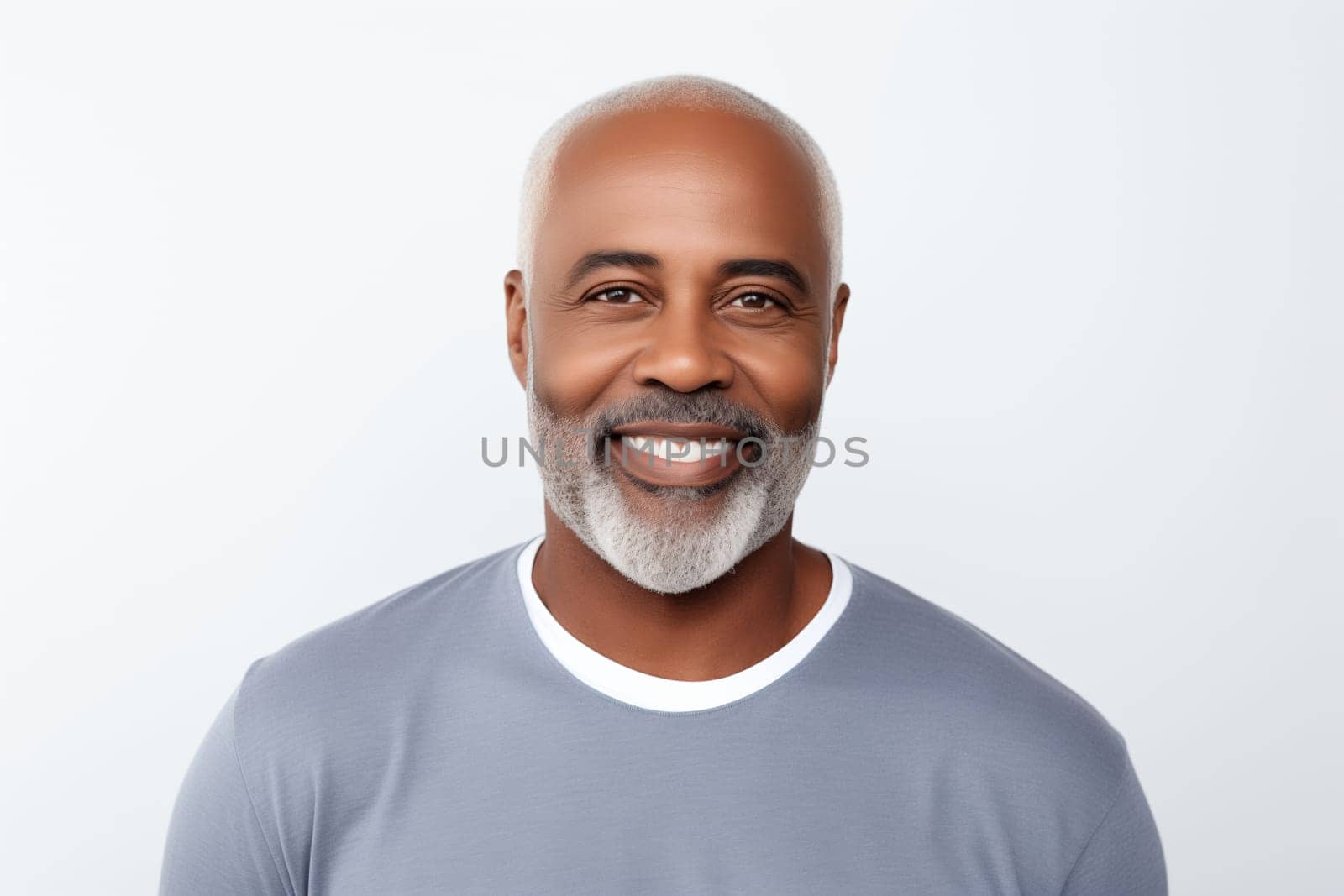 Portrait of handsome happy smiling mature african man with toothy smile, bearded, looking at camera on white studio background