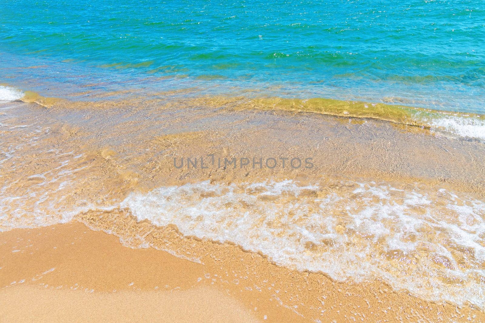 Soft blue ocean wave or clear sea on clean sandy beach summer concept.