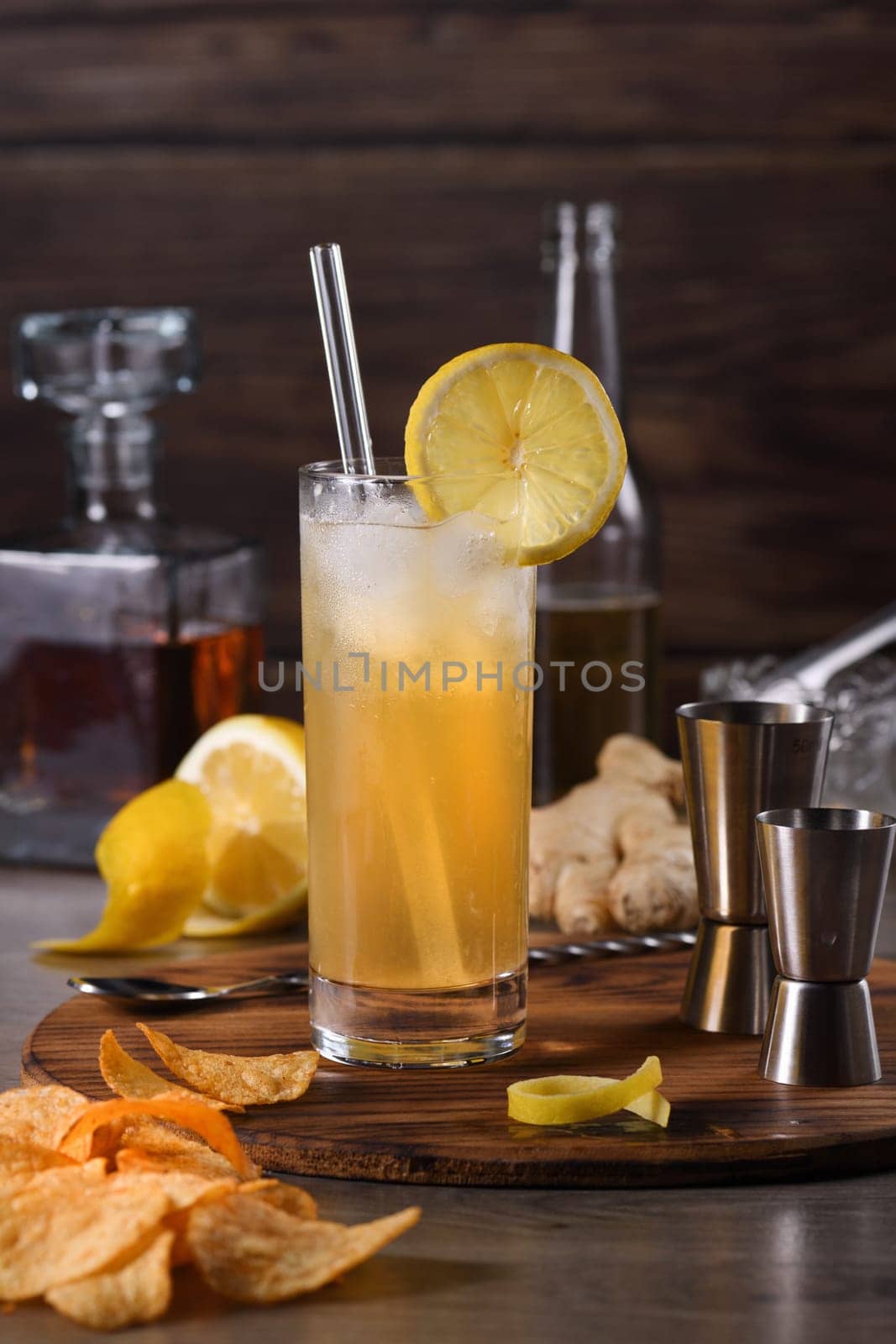 Whiskey cocktail with ginger beer, garnished with lemon 