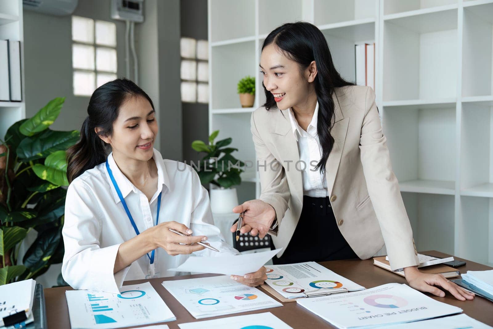 business woman discussing strategy in office. colleagues collaborating on business report.