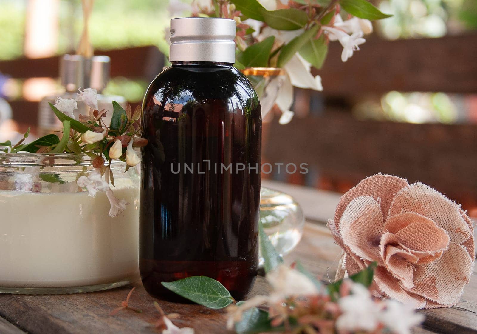 Bottle of scented oil decorated with a mix of flowers by VeroDibe