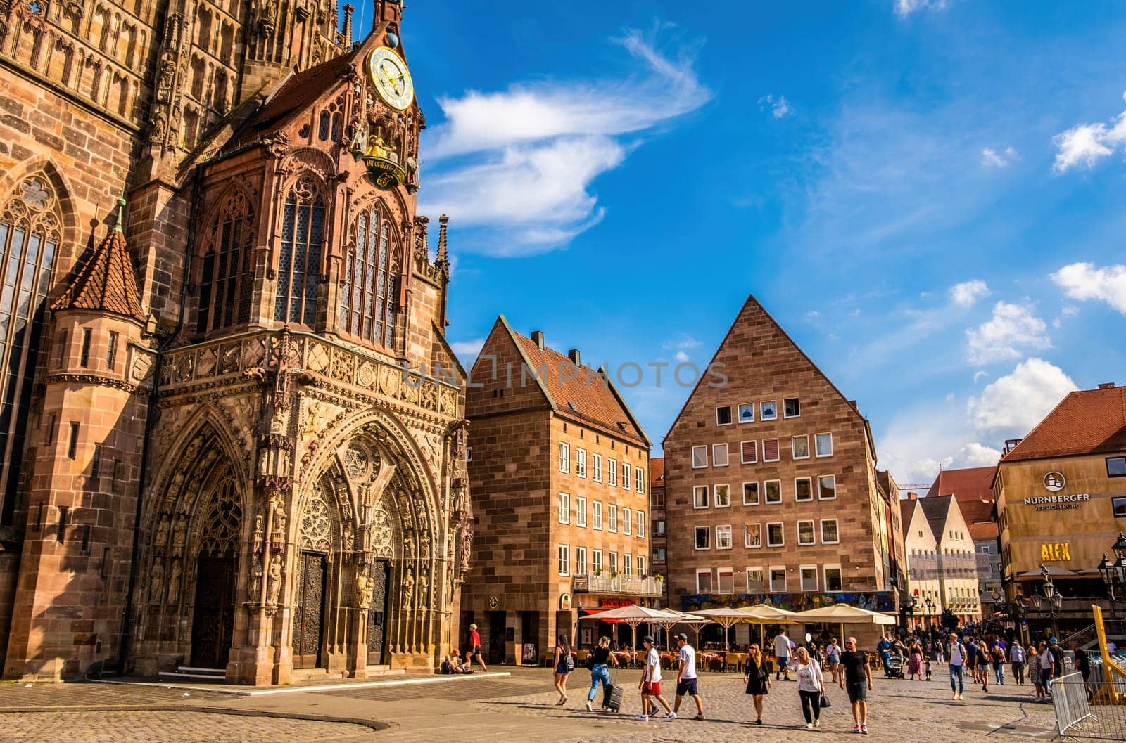 Nurnberg, Germany - 29 August 2022: Old city center square with tourists in Nuremberg, Germany. Historical travel destination in Bavaria region, Europe with beautiful houses and people