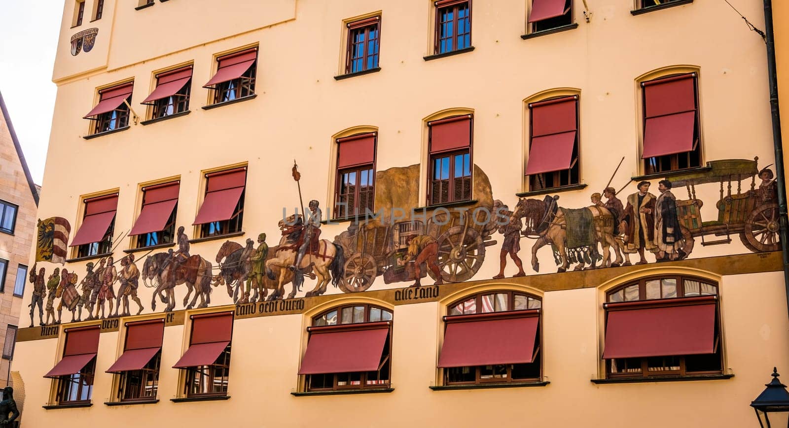 Nurnberg, Germany - 29 August 2022: Old building wall with traditional historical paintings in Nuremberg, Germany. Beautiful house drawings with horses in famous Bavaria region, Europe