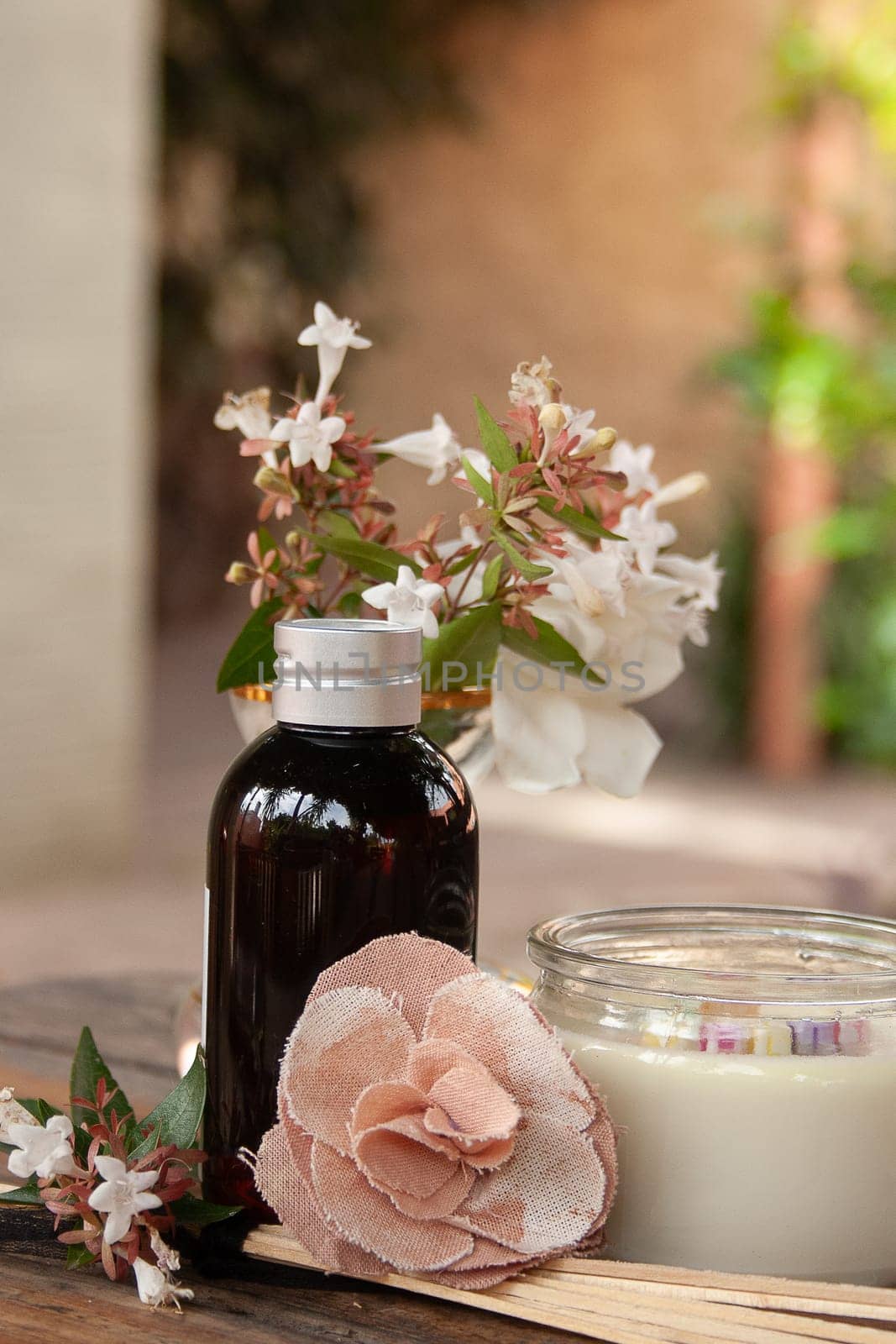 Spa set and mixed natural and fabric flowers on rustic table . by VeroDibe