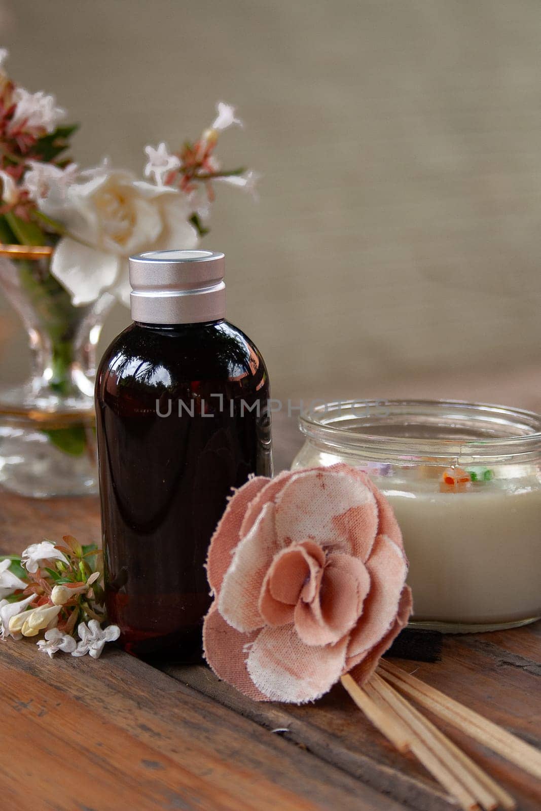 Aromatherapy set with flowes. Sap concept.Neutral grey background