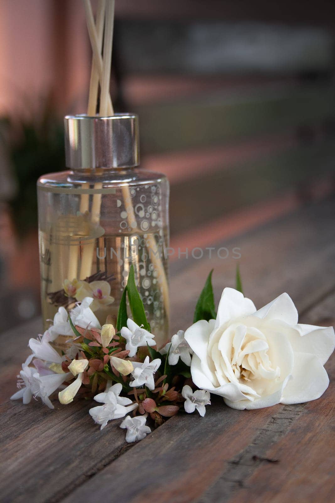 Aroma diffuser on rustic table decorated with natural flowers by VeroDibe