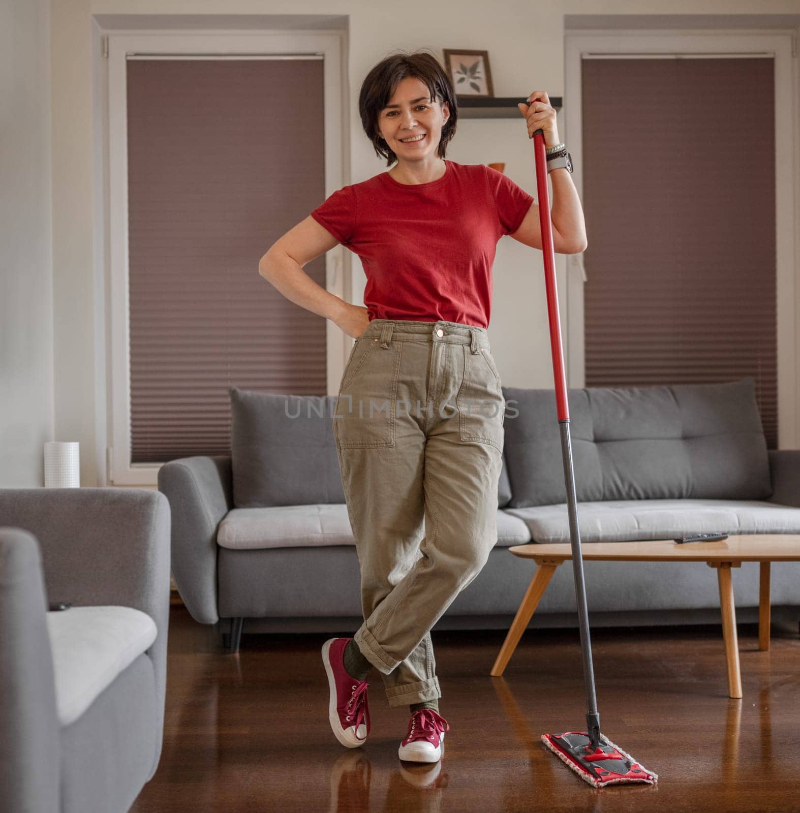 Cheerful Cleaner Stands In Room With Mop And Bucket, Washing Floor