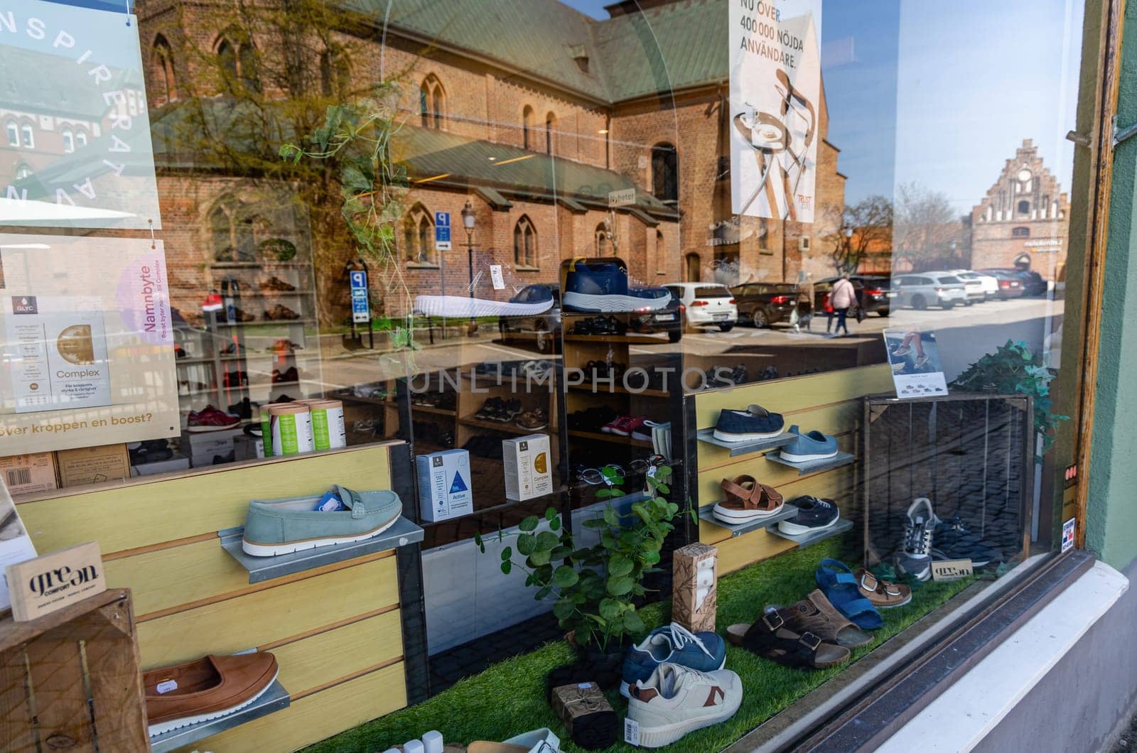Showcase window of a shoe store in the city of Ystad, Sweden - May 25, 2024.