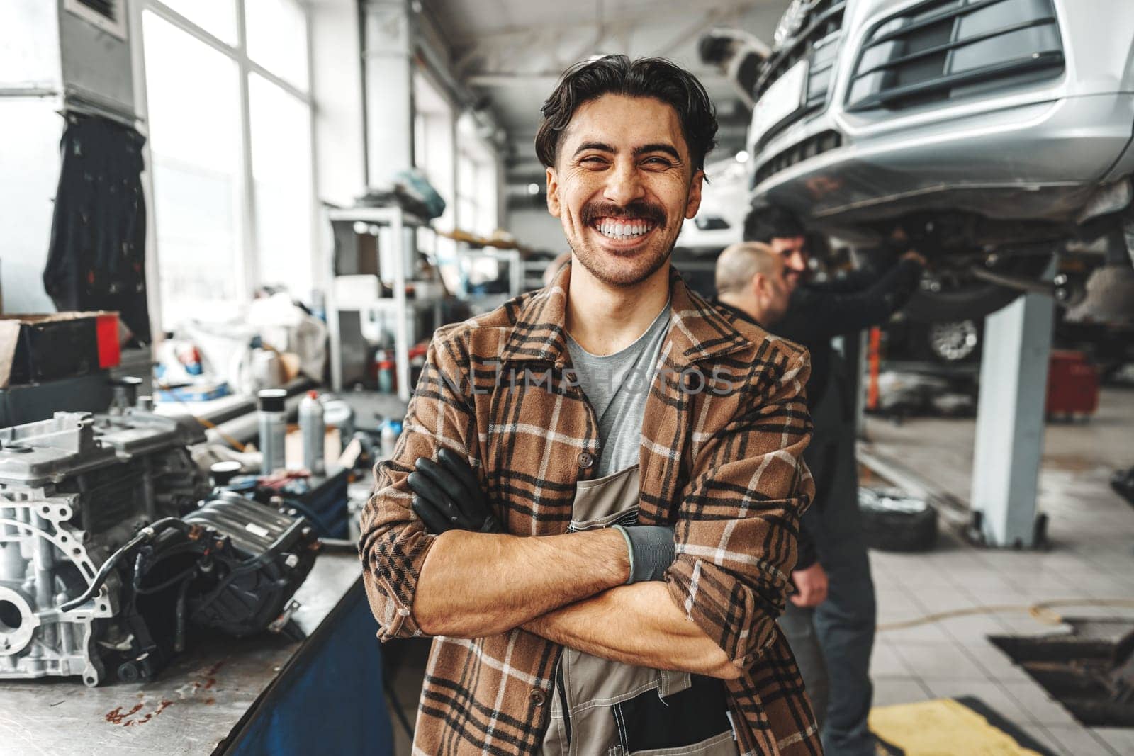 Portrait of a male mechanic in an auto repair shop close up