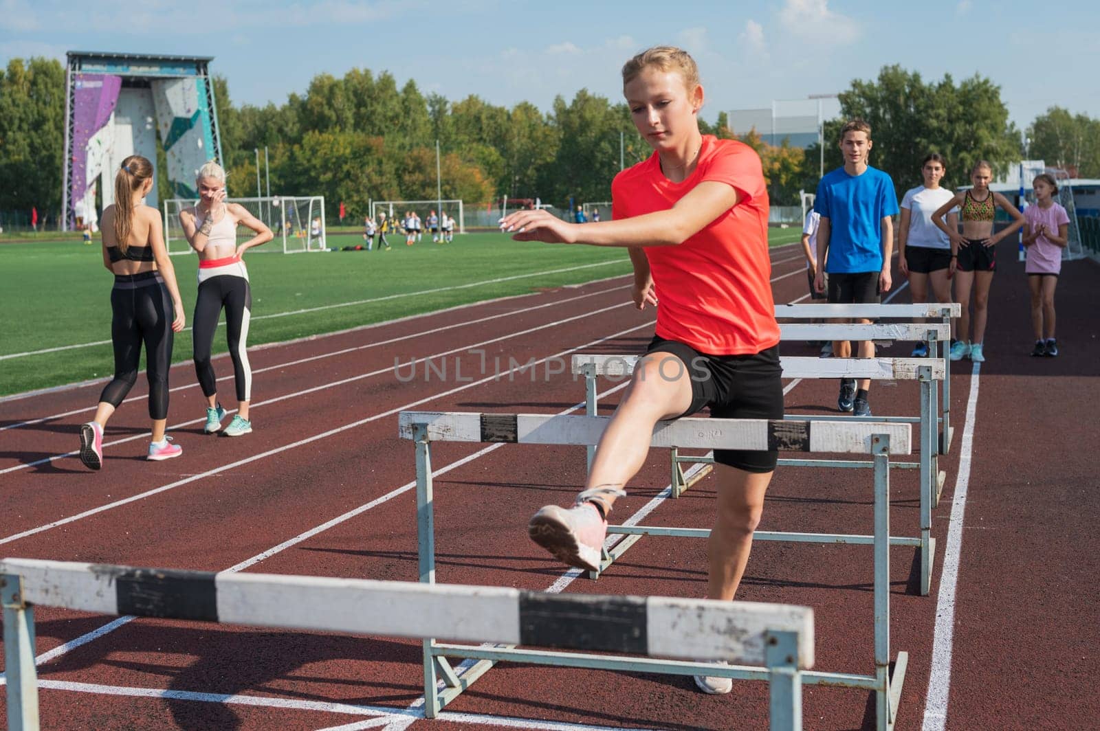 Group of young athletes training at the stadium. School gym trainings or athletics