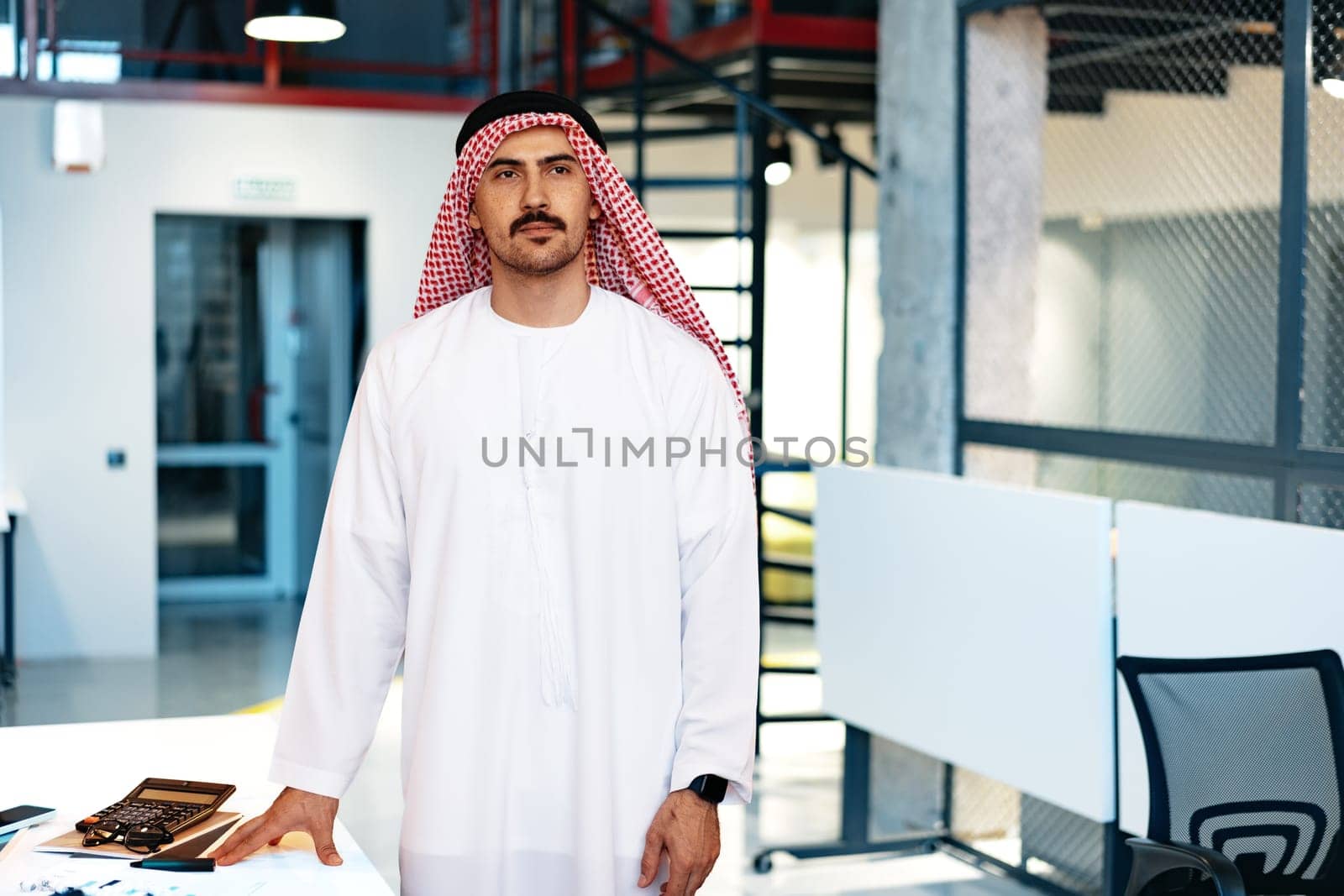Successful muslim businessmen in traditional outfit in his office, portrait
