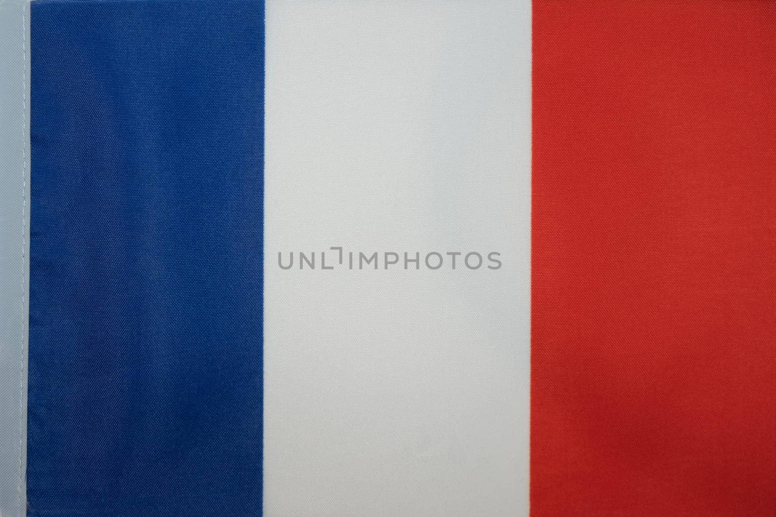 Simple Flag of France. French simple tricolor cloth fabric texture flag. Blue, white and red. Marianne. High quality photo