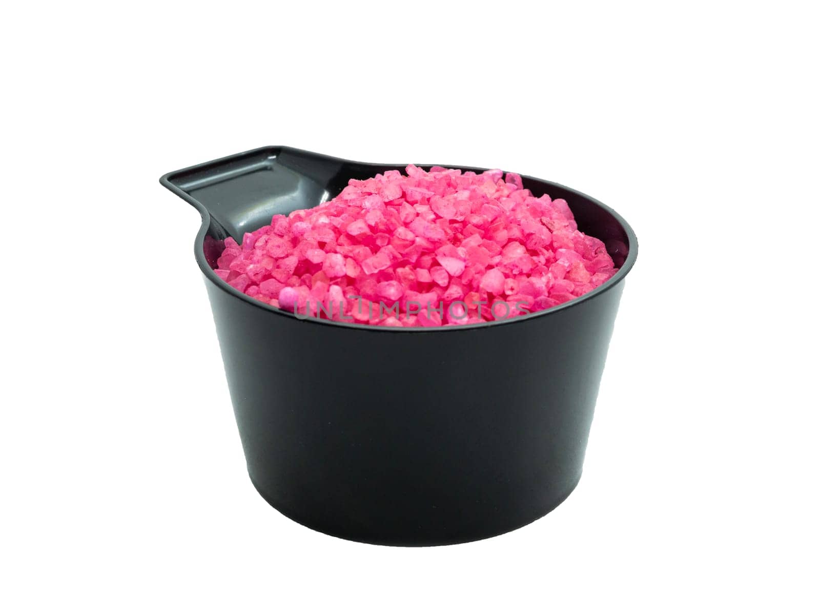 pink bath salt in a black cup isolated. spa concept