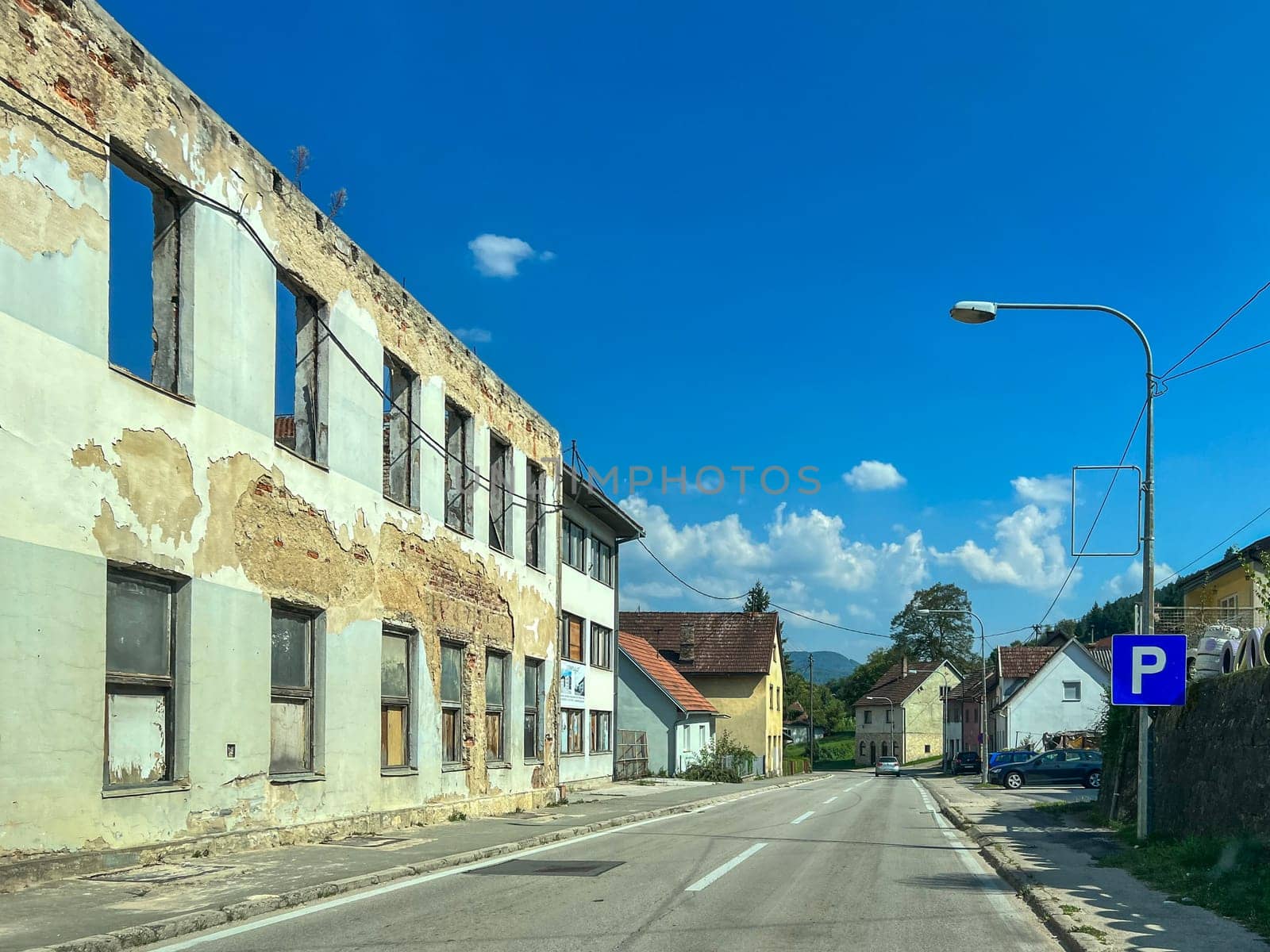 Kljuc, Bosnia and Herzegovina, August 23, 2023: War-damaged and abandoned buildings against the sky by stan111