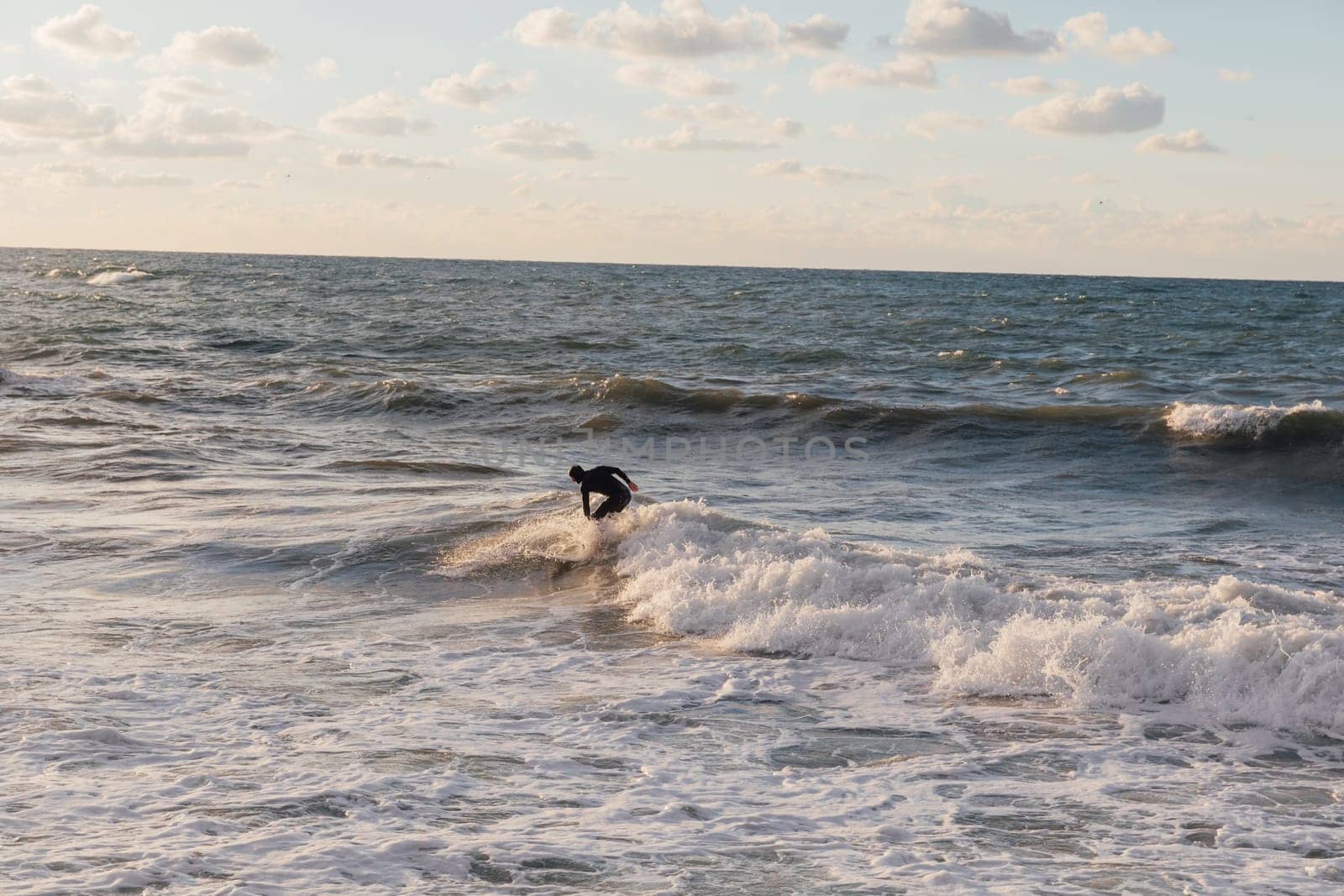 Athletes riding a surfboard on the waves