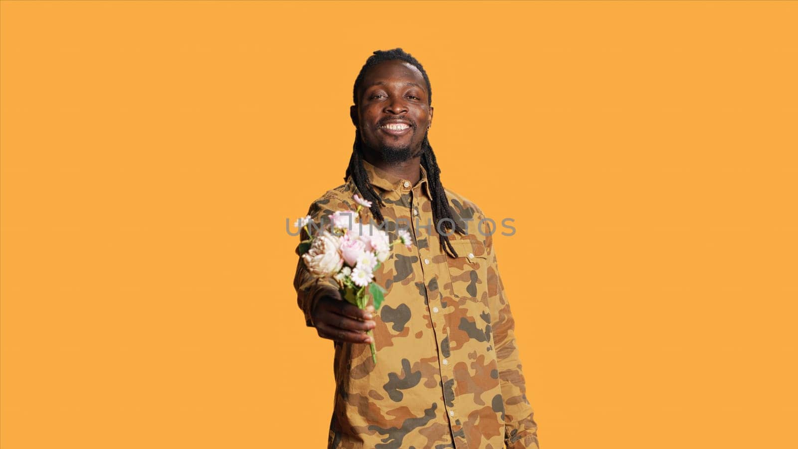 Romantic person offering flowers bouquet to someone, going on a date and expressing his honest feelings. African american man giving roses to his girlfriend, lovely sweet gesture.