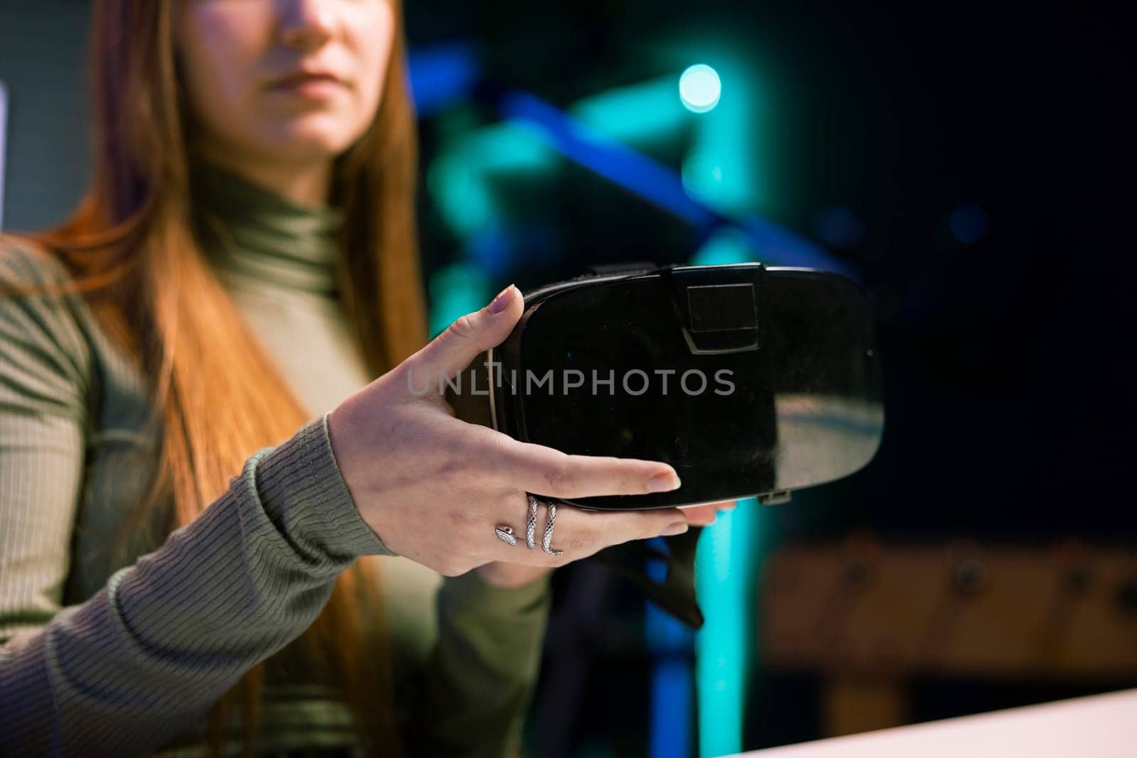 Gen Z tech content creator filming technology review of newly released VR goggles, unboxing them and presenting specifications to audience. Influencer showing virtual reality device to fans, close up
