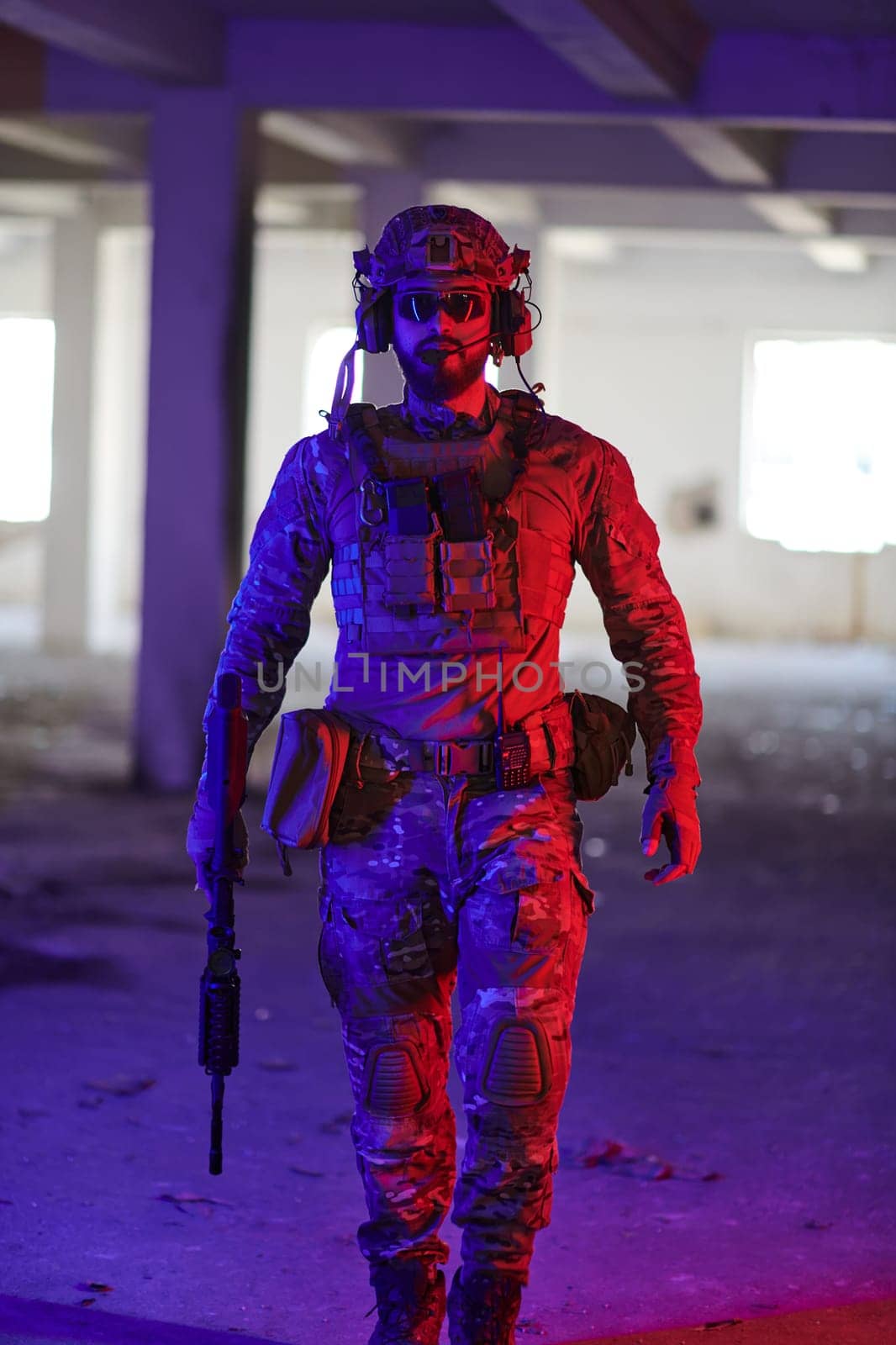 A professional soldier undertakes a perilous mission in an abandoned building illuminated by neon blue and purple lights.