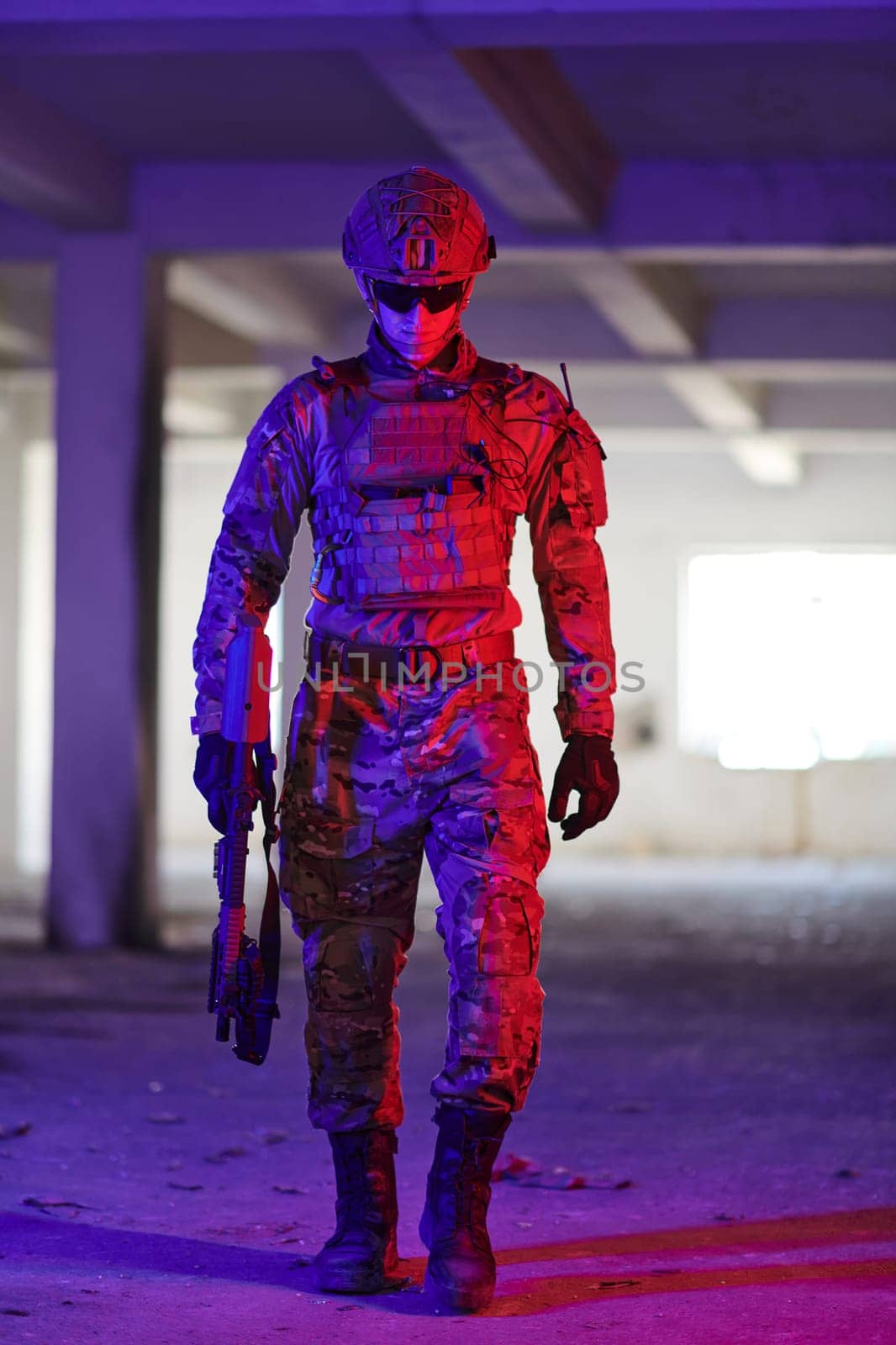 A professional soldier undertakes a perilous mission in an abandoned building illuminated by neon blue and purple lights.