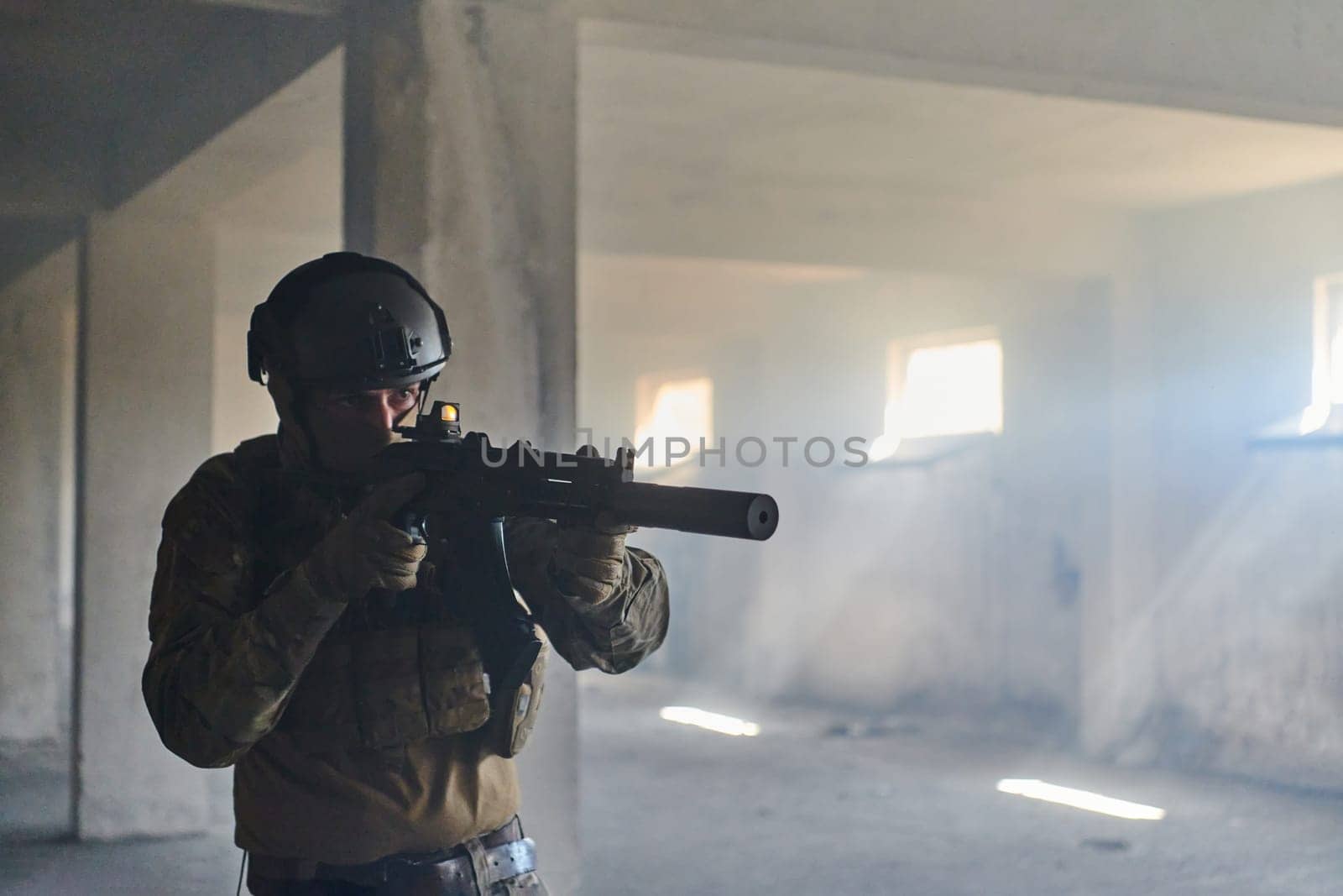 A professional soldier in an abandoned building shows courage and determination in a war campaign.