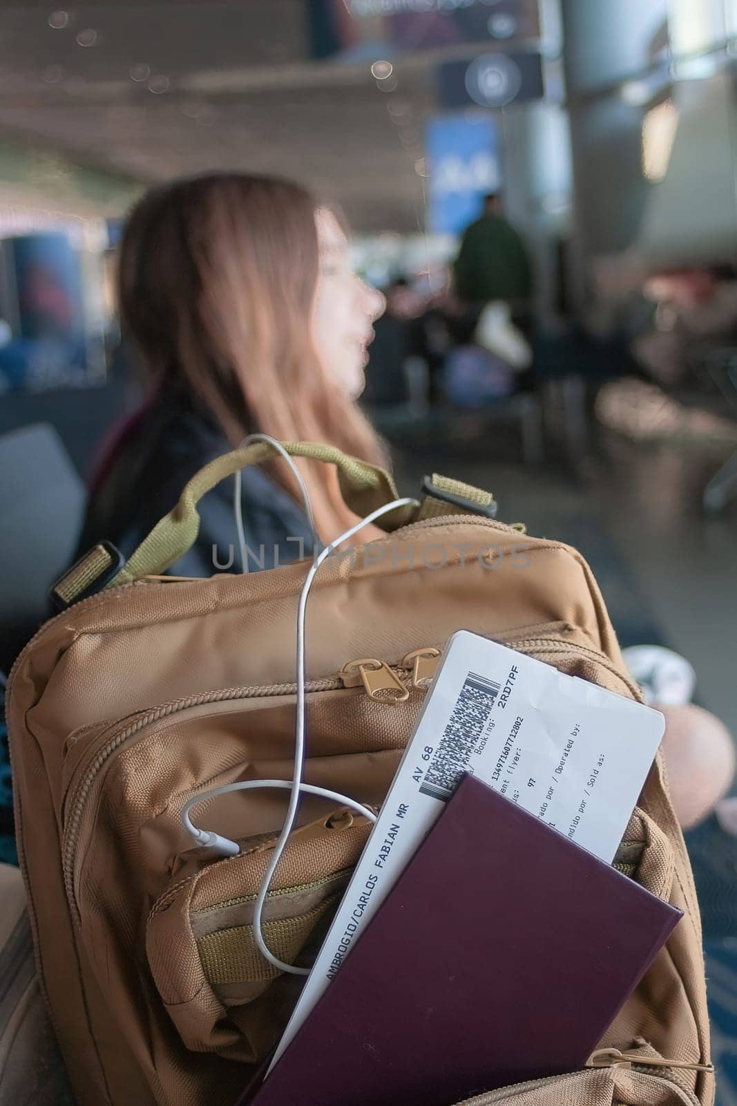 Young passenger's rucksack and documents on an international flight.