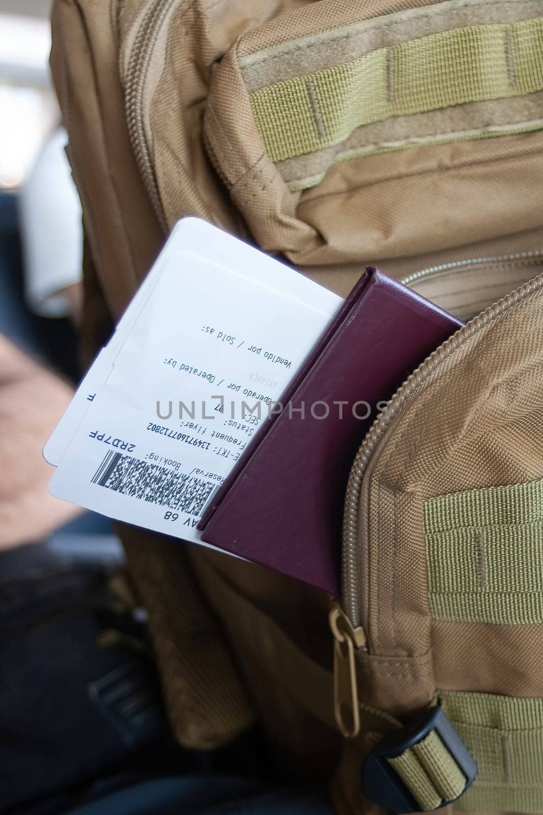 Backpack and travel documents of a passenger on an international flight.