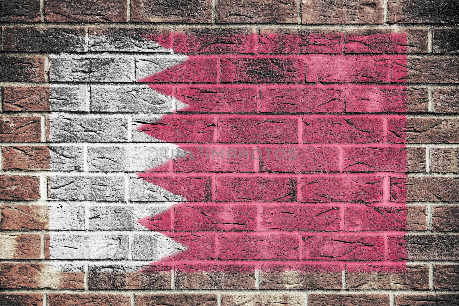 A Bahrain flag on a brick wall background