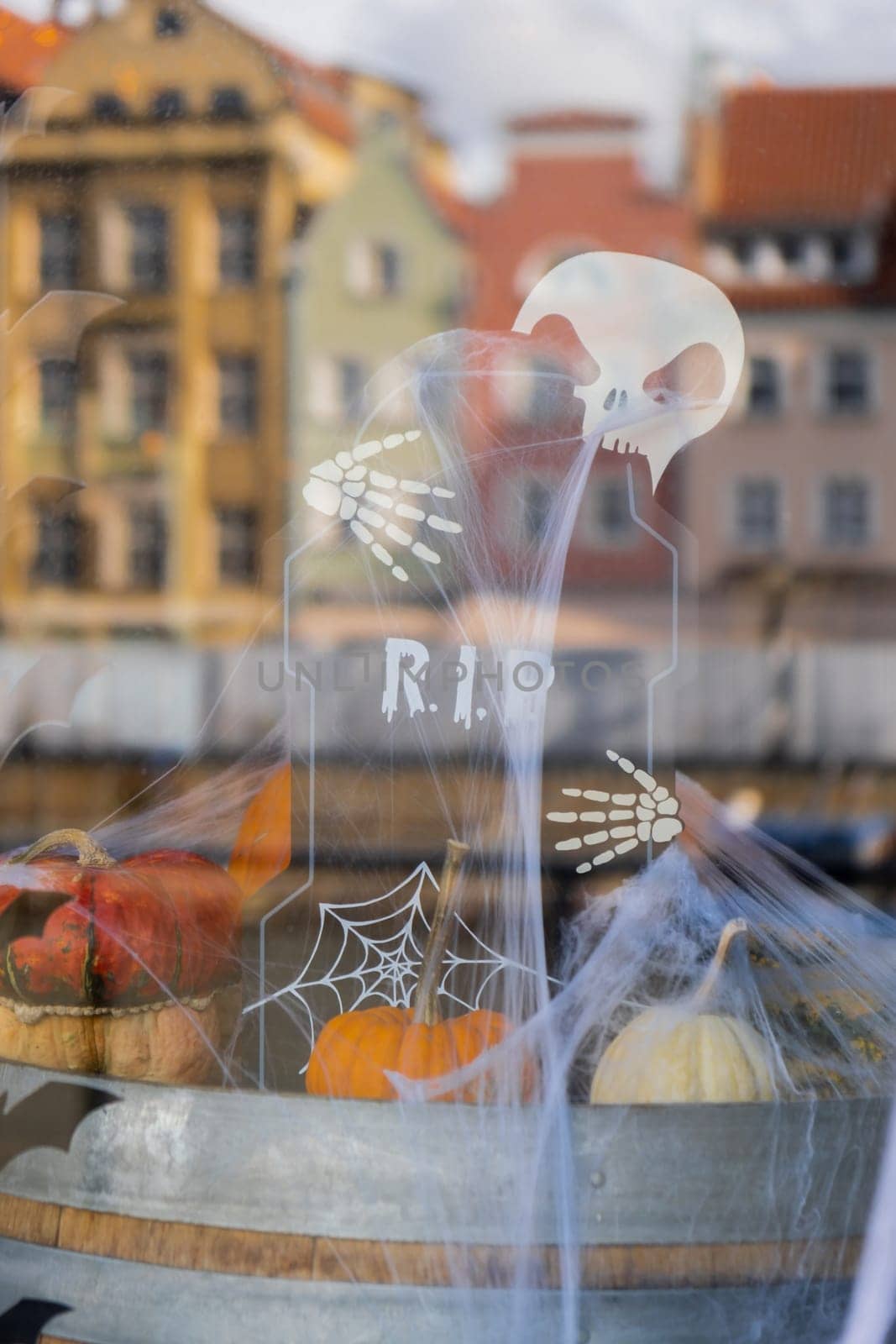 Halloween decorated outdoor cafe or restaurant terrace in America or Europe with pumpkins and Skeletons skull with tombstones RIP sign traditional attributes of Halloween. Frontyard decoration for party.