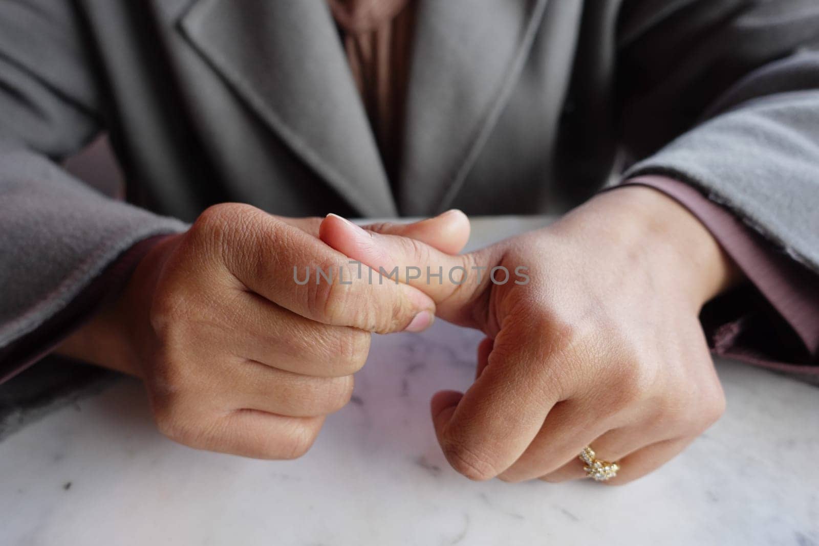 Young women hands suffering thumb pain