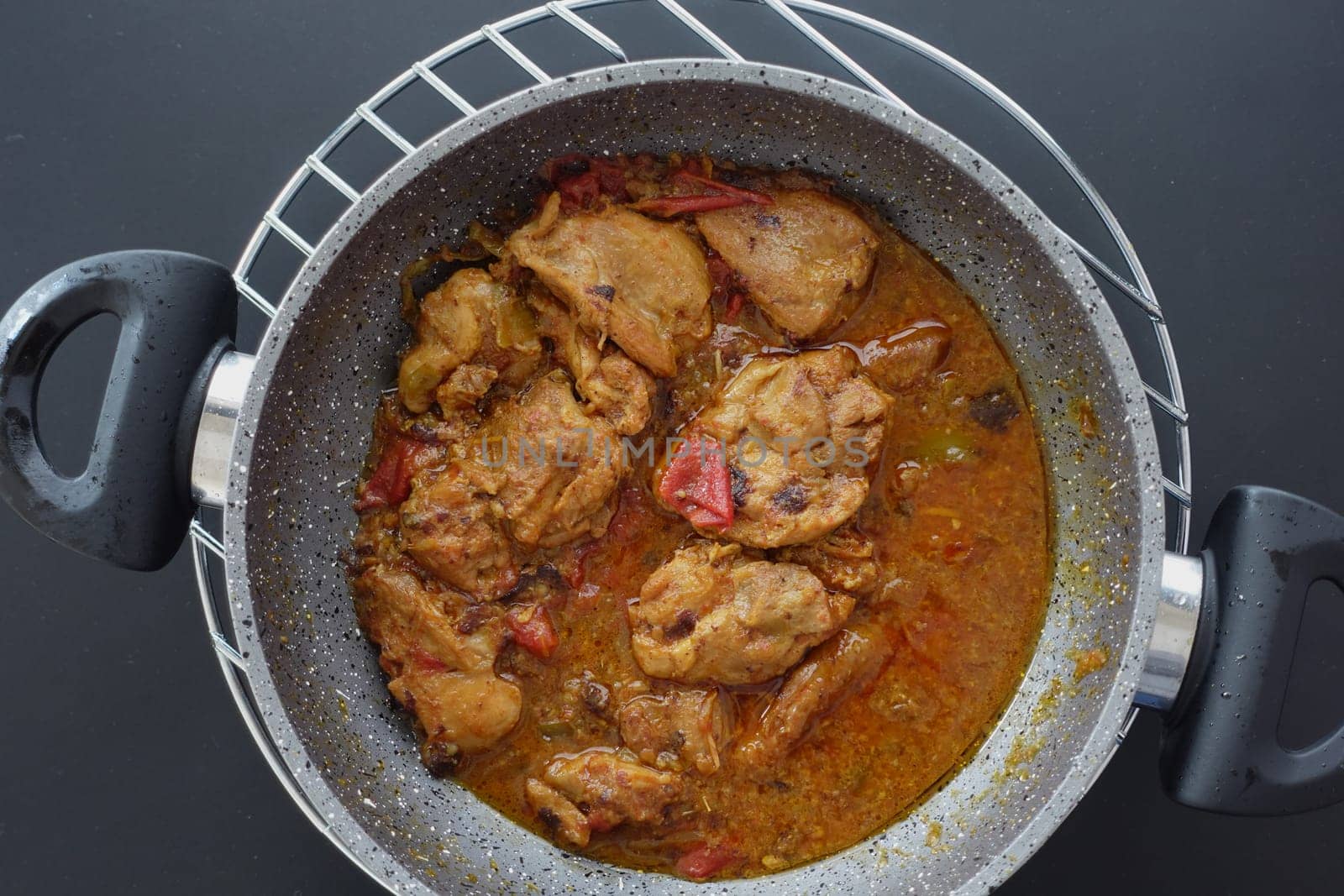 Chicken curry or masala in a bowl on table .