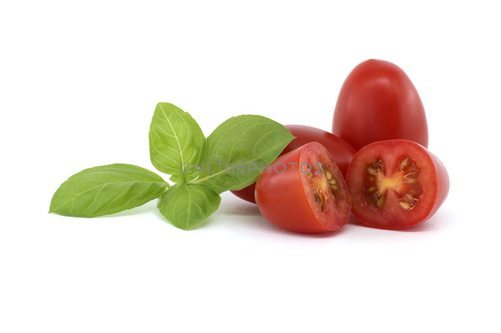 Close-up of fresh Roma tomatoes, including halved ones, alongside basil leaves on a white background. Perfect for illustrating healthy eating and fresh ingredients.