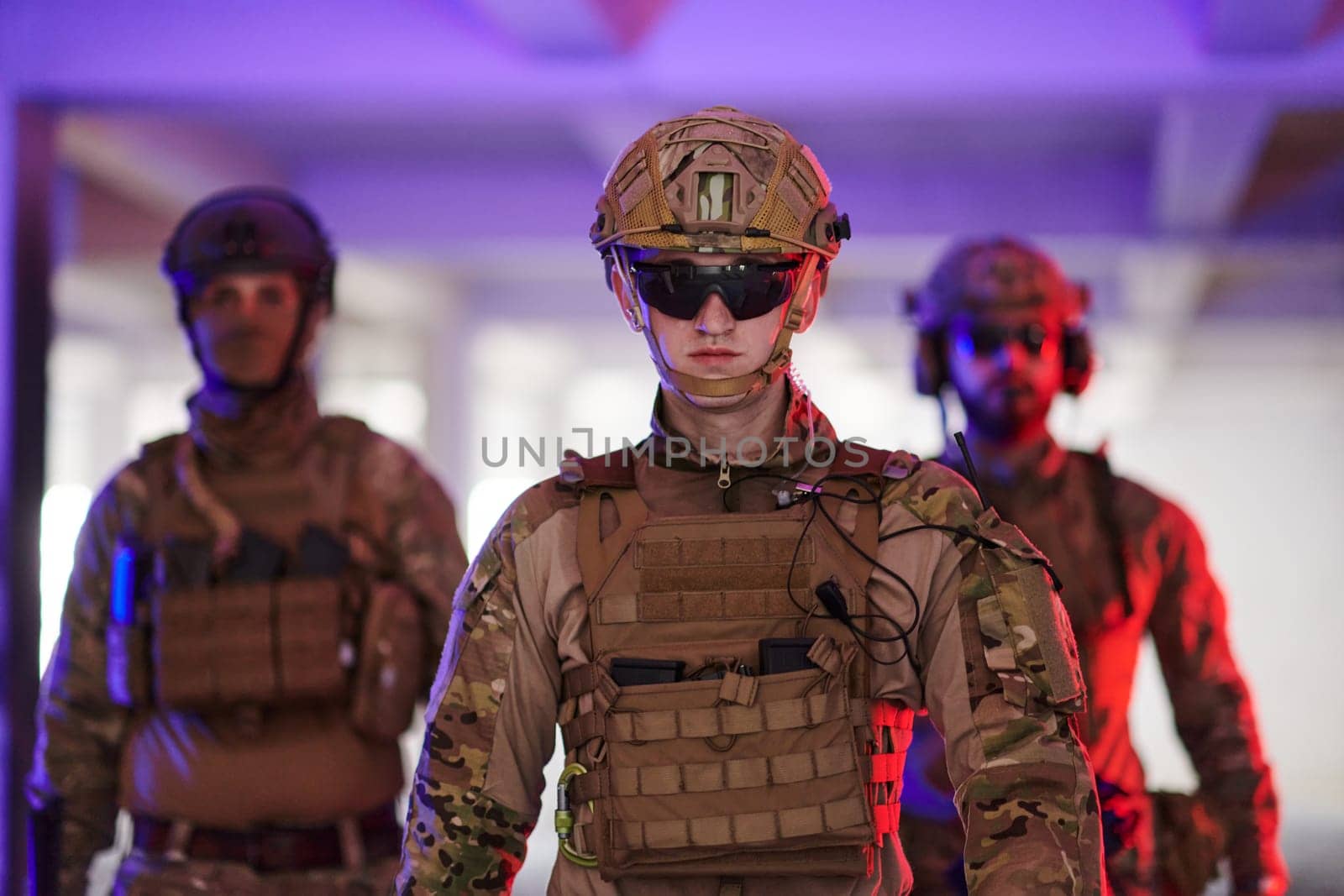 soldier squad team walking in urban environment colored lightis.