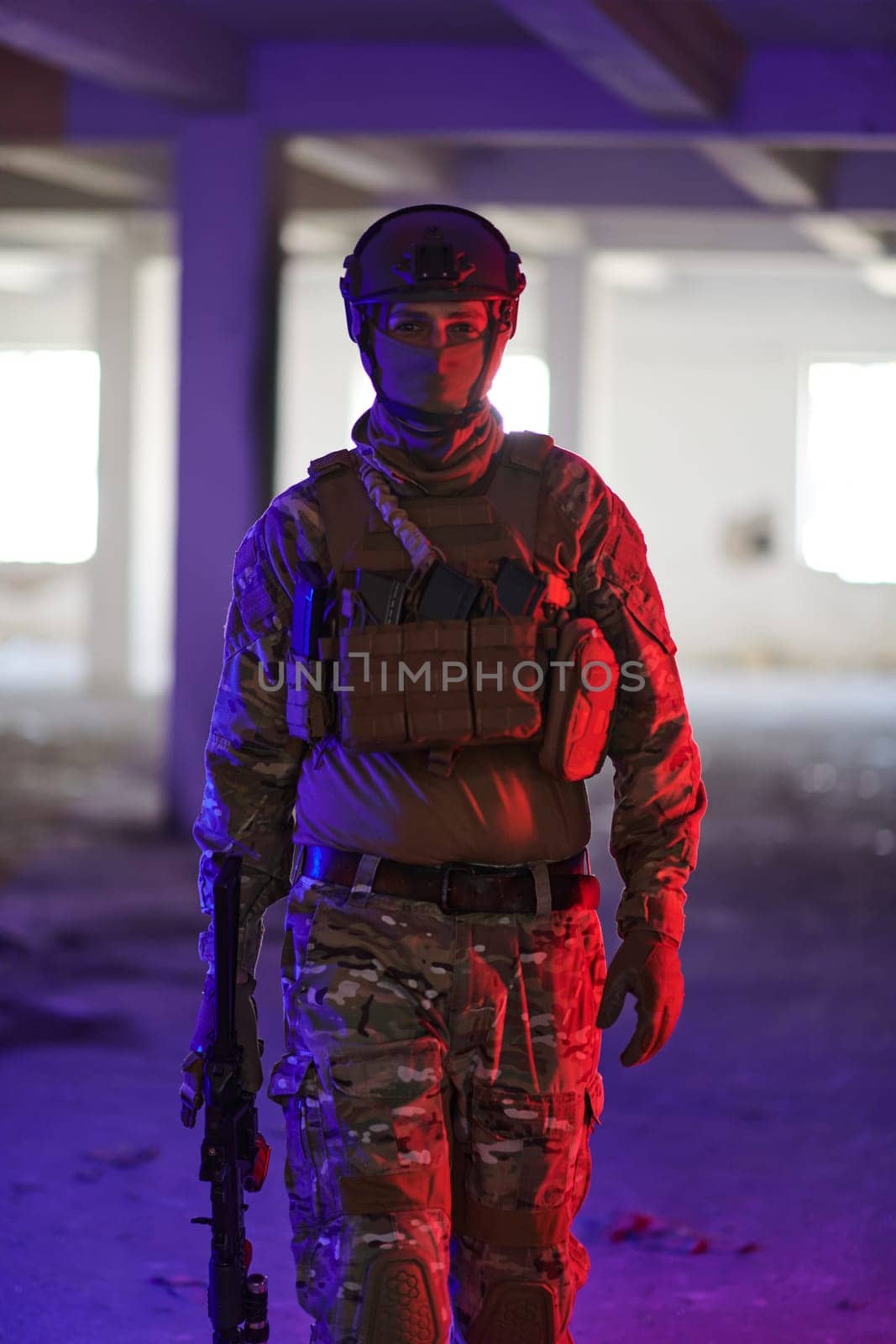 A professional soldier undertakes a perilous mission in an abandoned building illuminated by neon blue and purple lights.