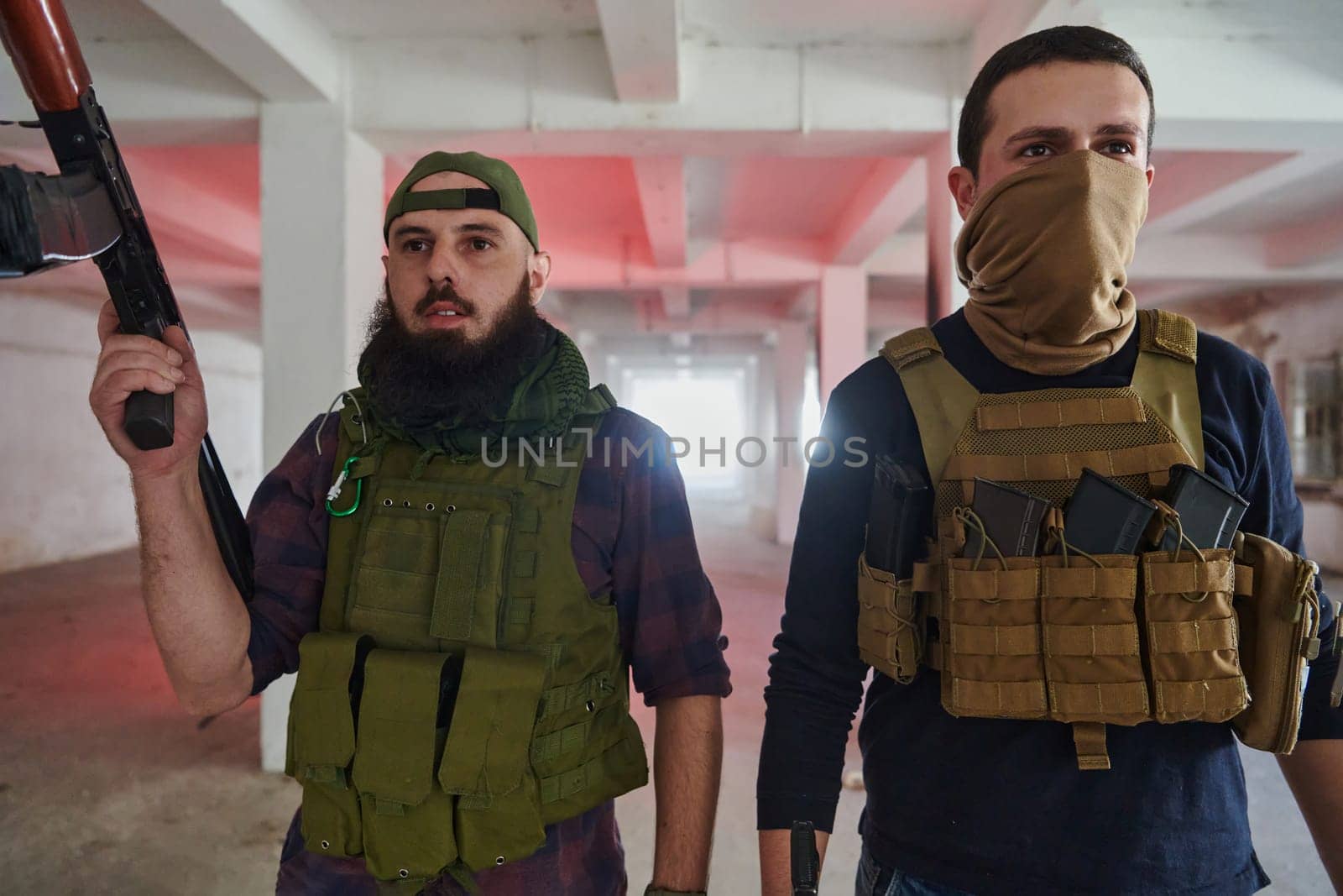 An abandoned building serves as the stronghold for a team of terrorists, fiercely guarding their occupied territory with guns and military equipment.