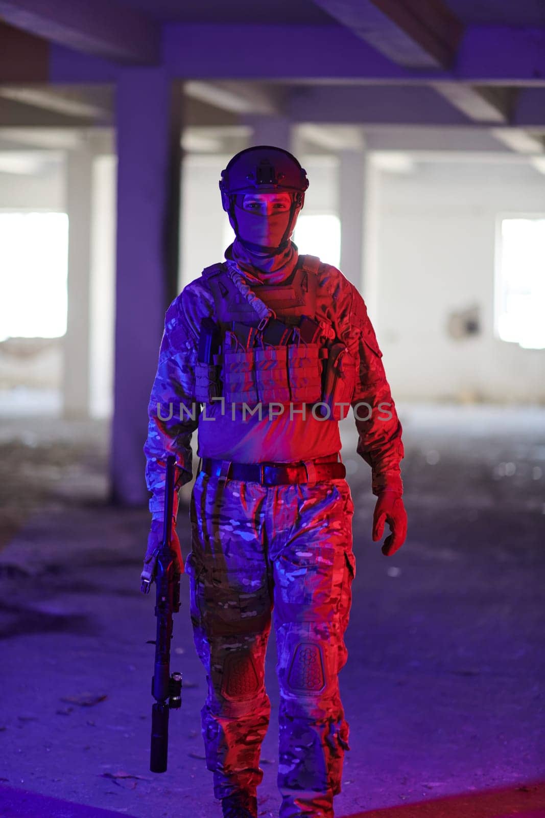 A professional soldier undertakes a perilous mission in an abandoned building illuminated by neon blue and purple lights.