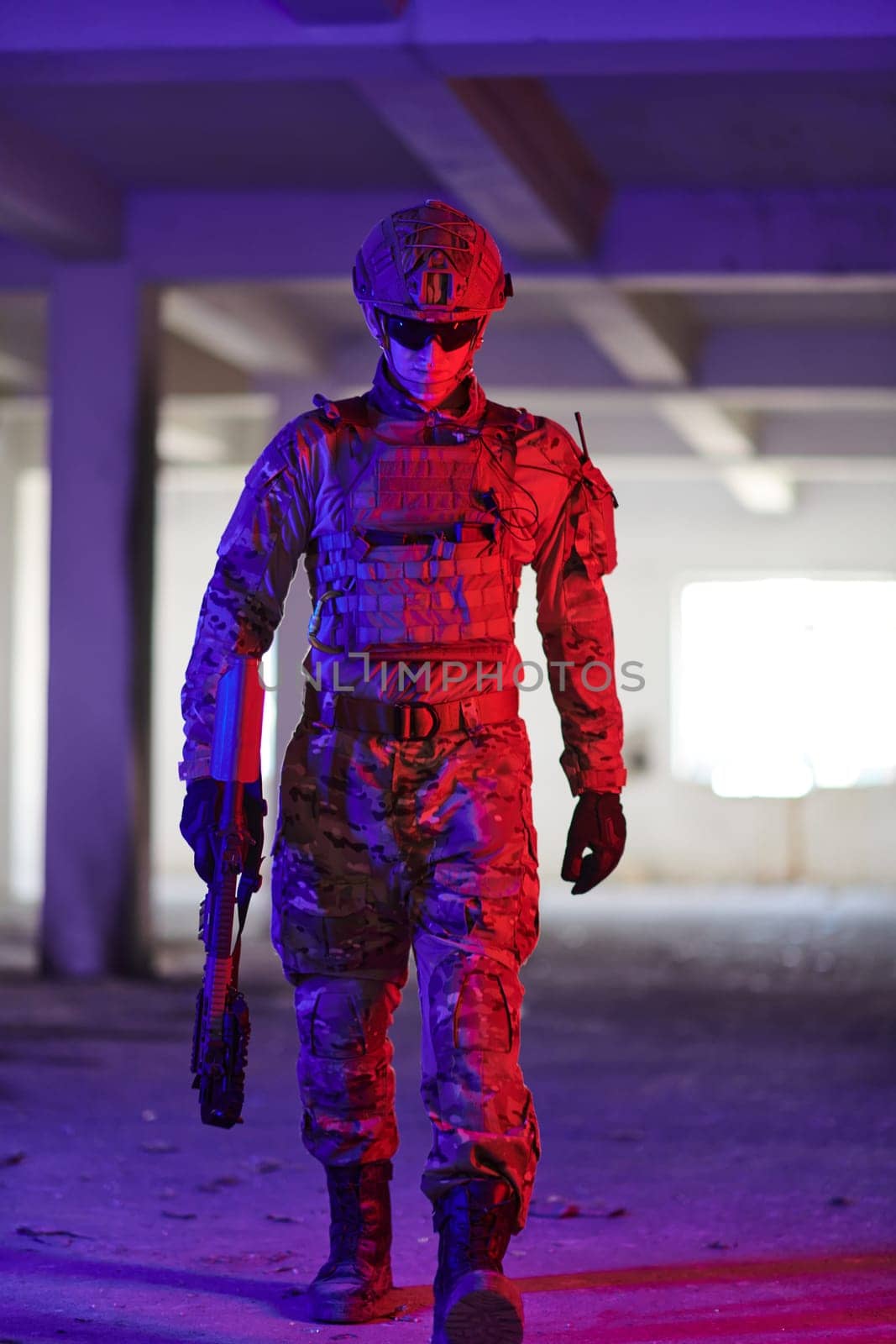 A professional soldier undertakes a perilous mission in an abandoned building illuminated by neon blue and purple lights.