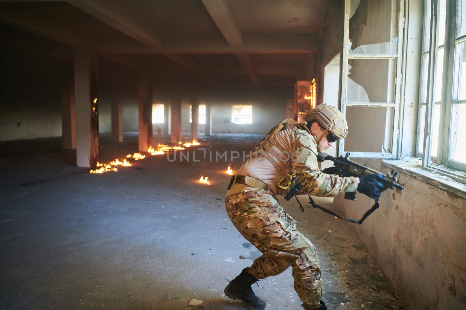 A professional soldier carries out a dangerous military mission in an abandoned building.