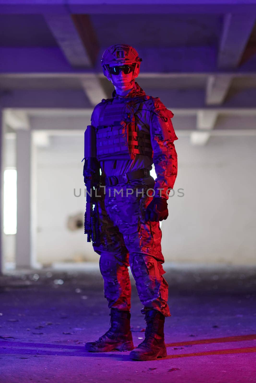 A professional soldier undertakes a perilous mission in an abandoned building illuminated by neon blue and purple lights.