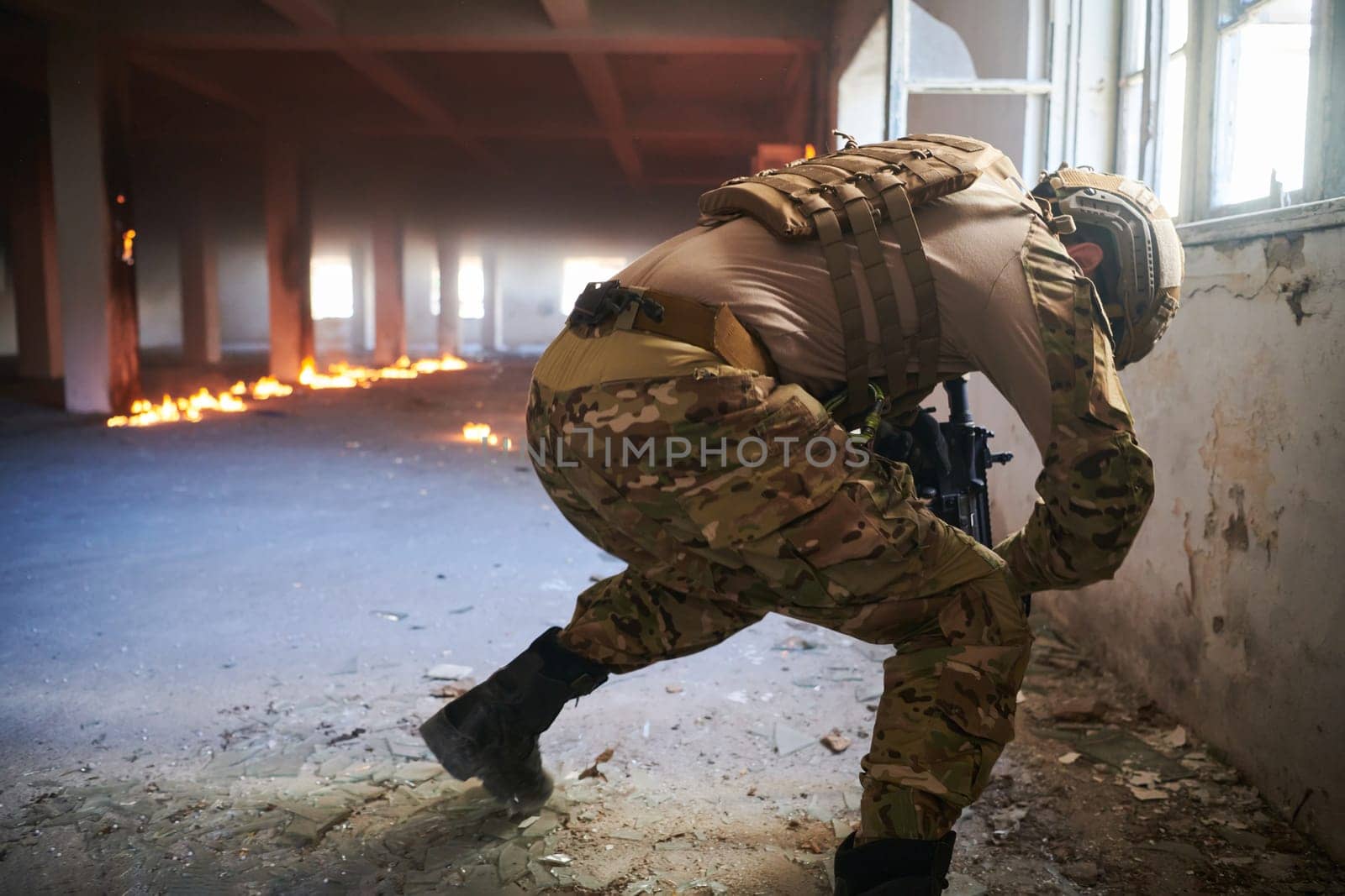 A professional soldier carries out a dangerous military mission in an abandoned building.