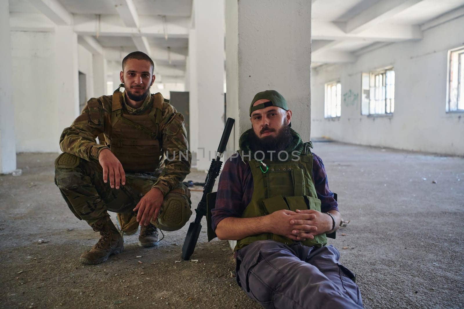 Group of soldiers discusses military tactics while situated in an abandoned building, meticulously planning their moves with focus and determination. by dotshock