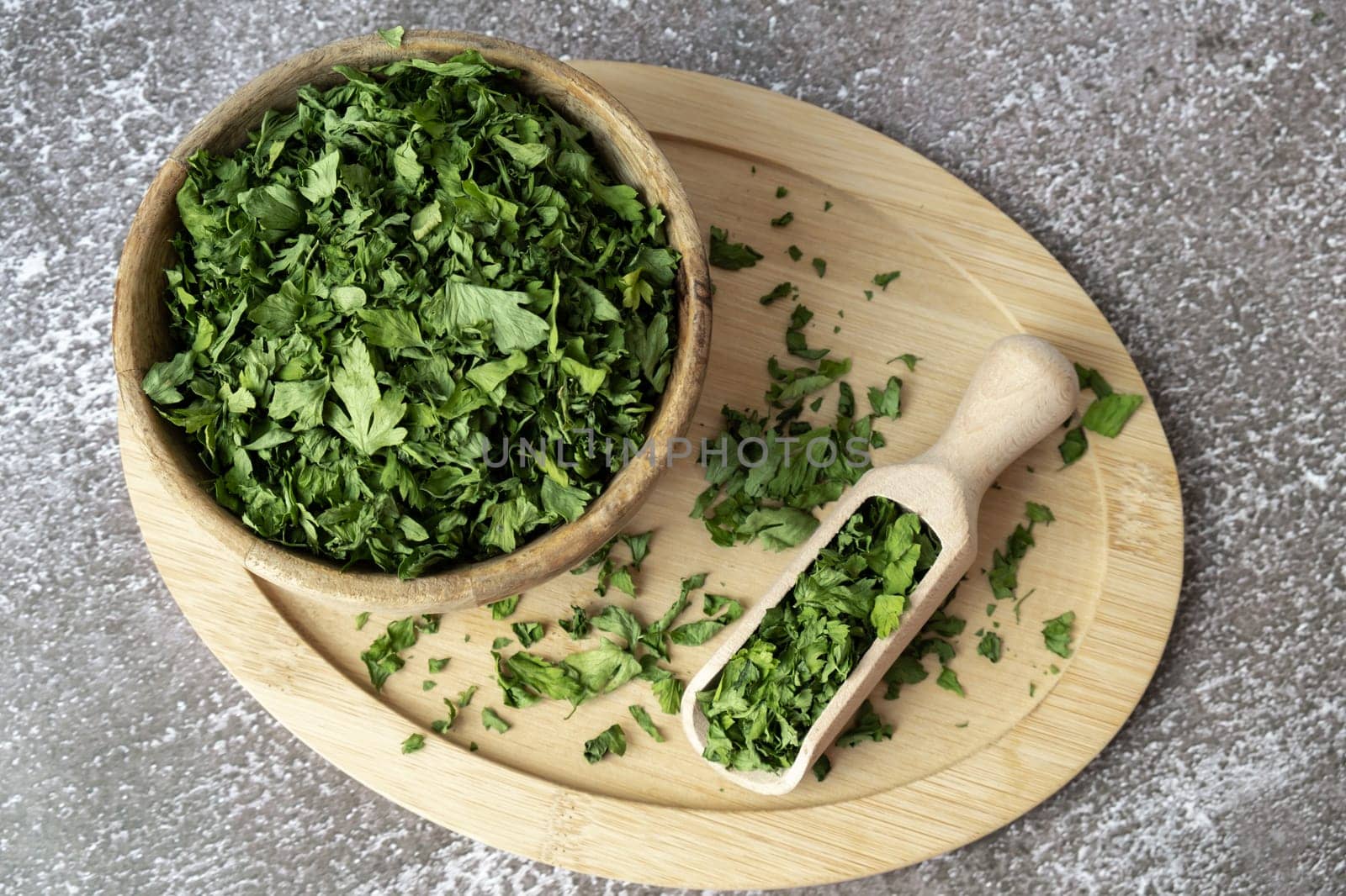 Wooden bowl with green dry parsley. Vegetarian bio organic salad herb healthy eating. Home garden immunity-boosting herbs. Seasonal harvest cottagecore